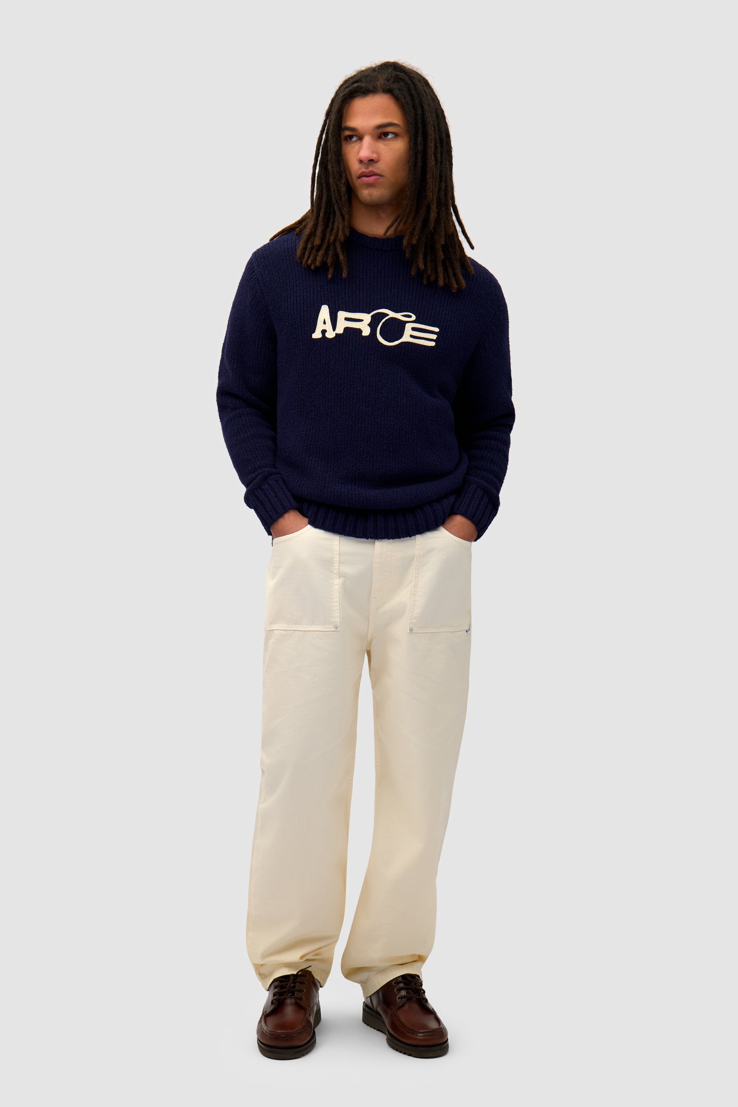 Logo Knit Sweater in Navy worn by a model, full-body front view