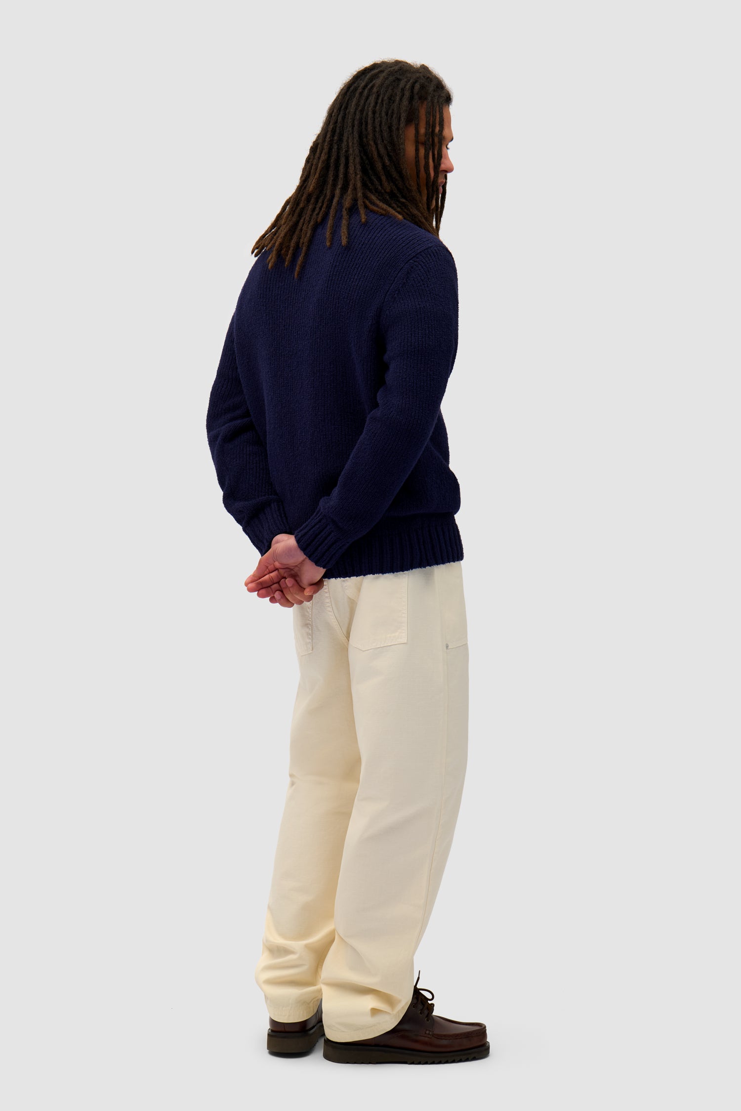 Logo Knit Sweater in Navy worn by a model, full-body back view