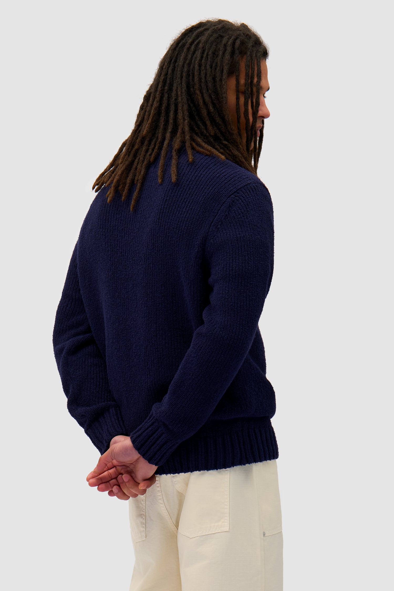 Logo Knit Sweater in Navy worn by a model, half-body back view