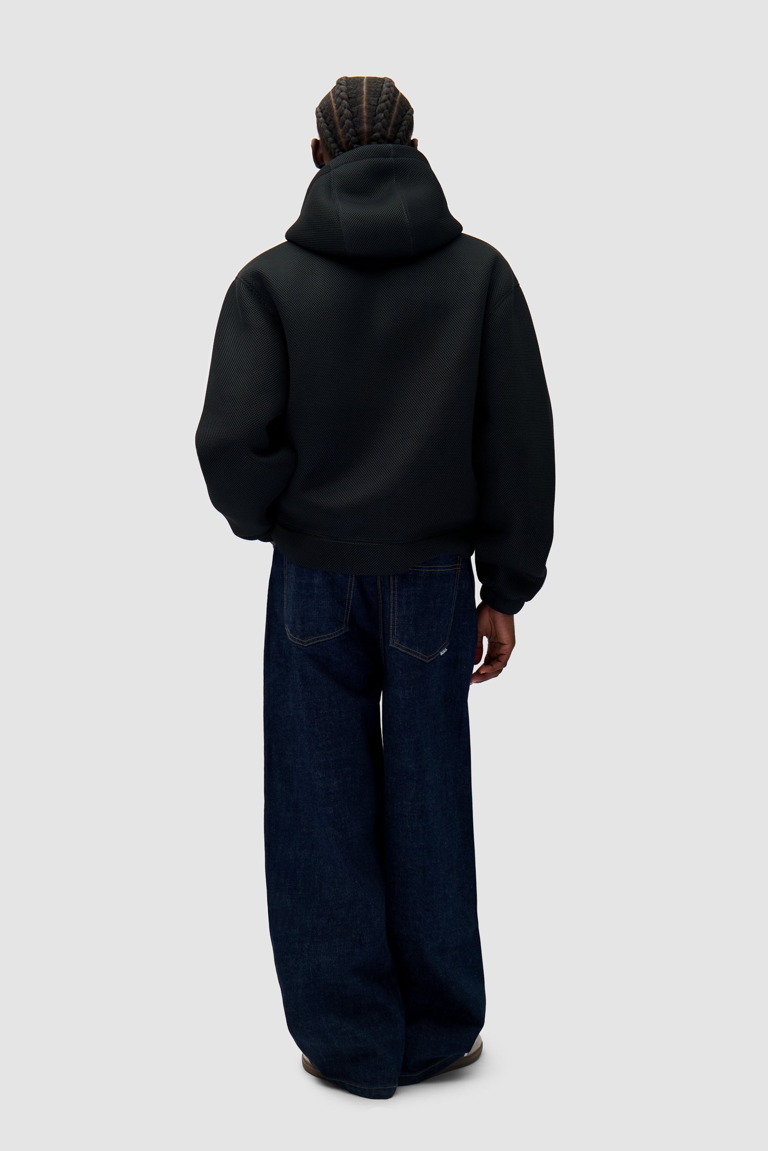 Mesh Hooded Jacket in Black worn by a model, full-body back view