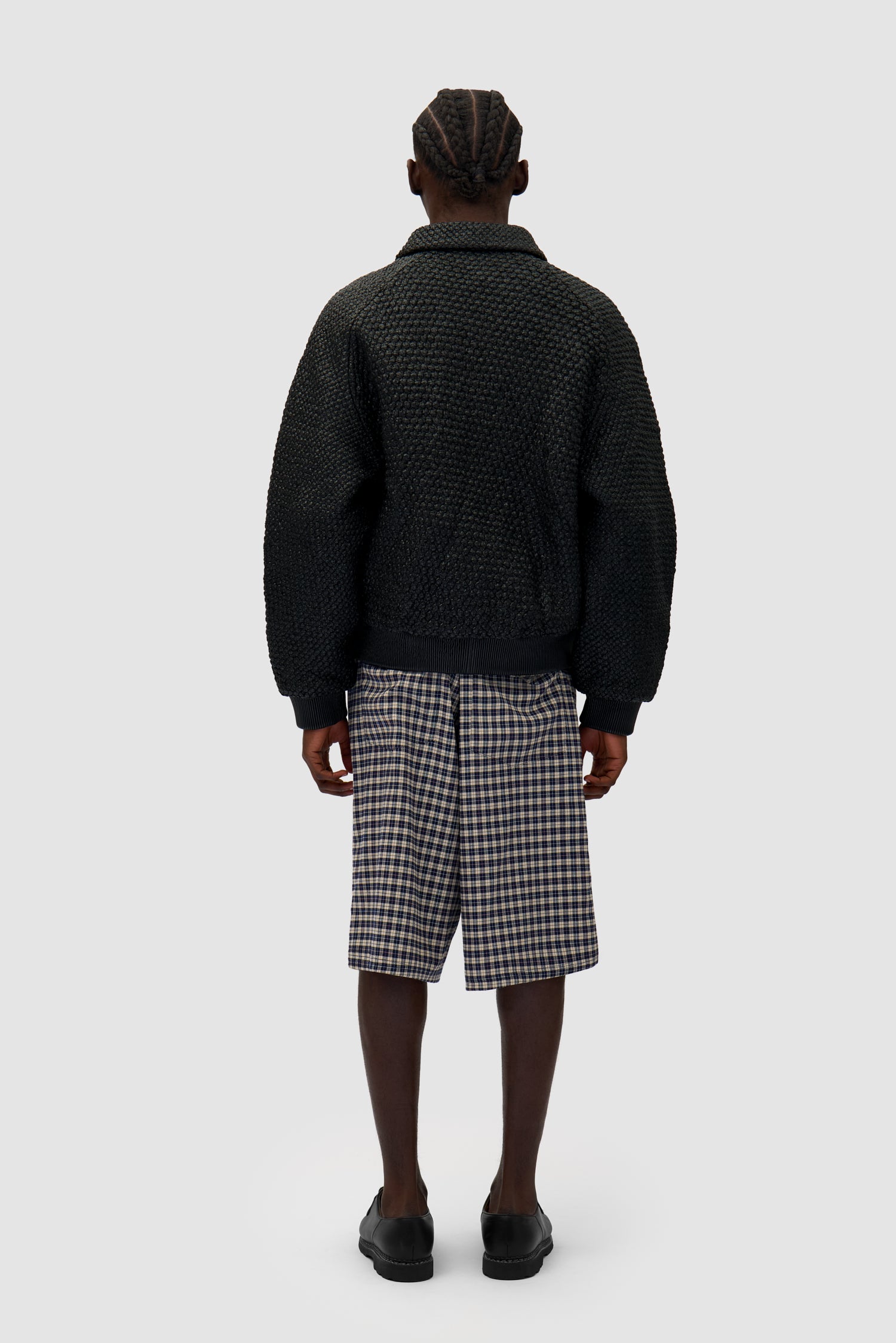 Leather Braided Jacket in Black worn by a model, full-body back view