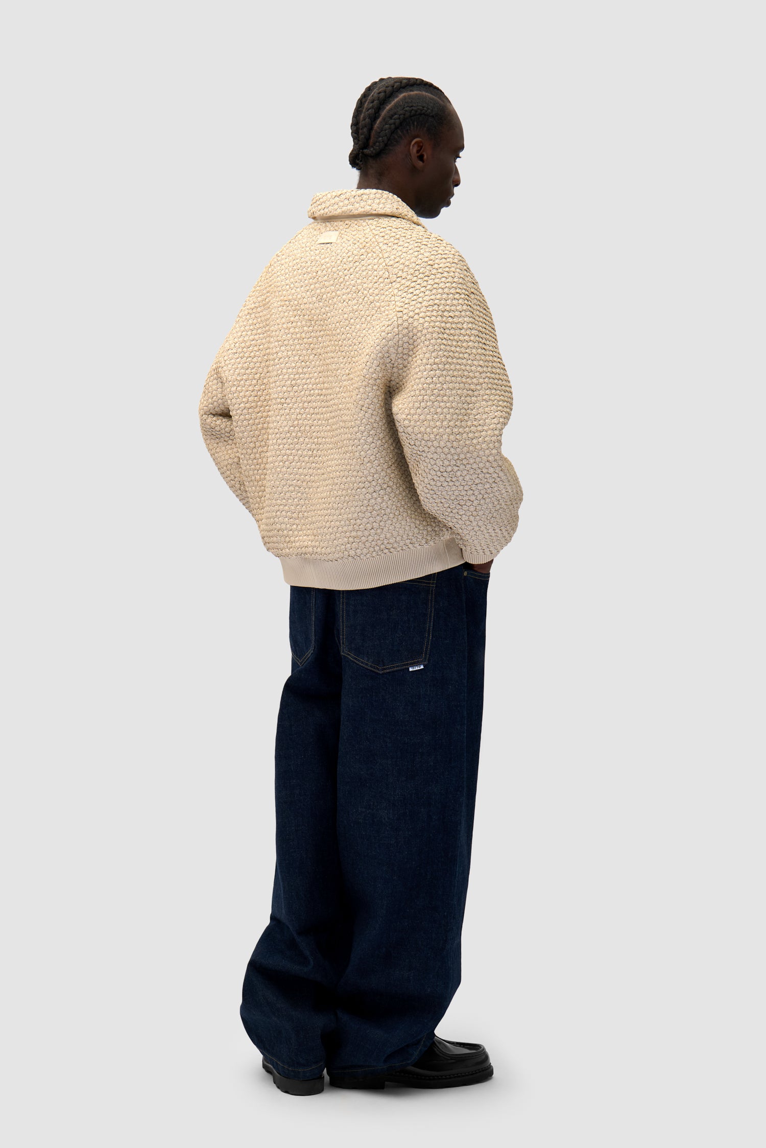 Leather Braided Jacket in Cream worn by a model, full-body side view