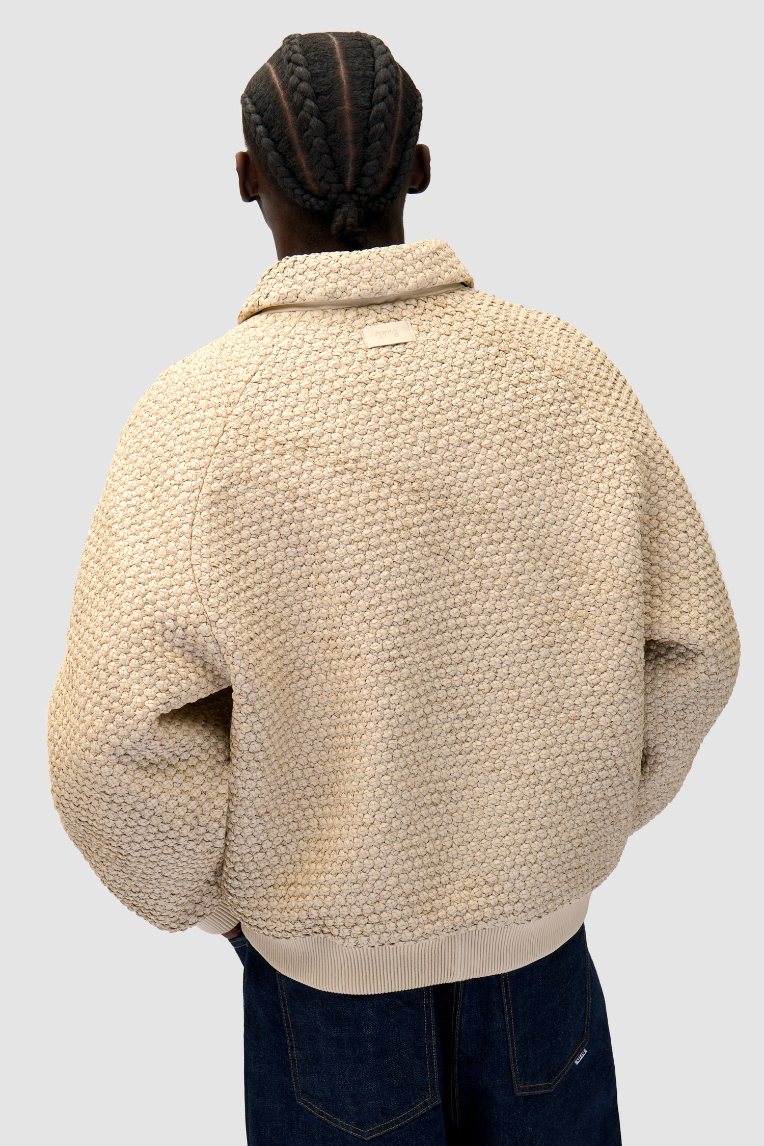 Leather Braided Jacket in Cream worn by a model, half-body detailed view