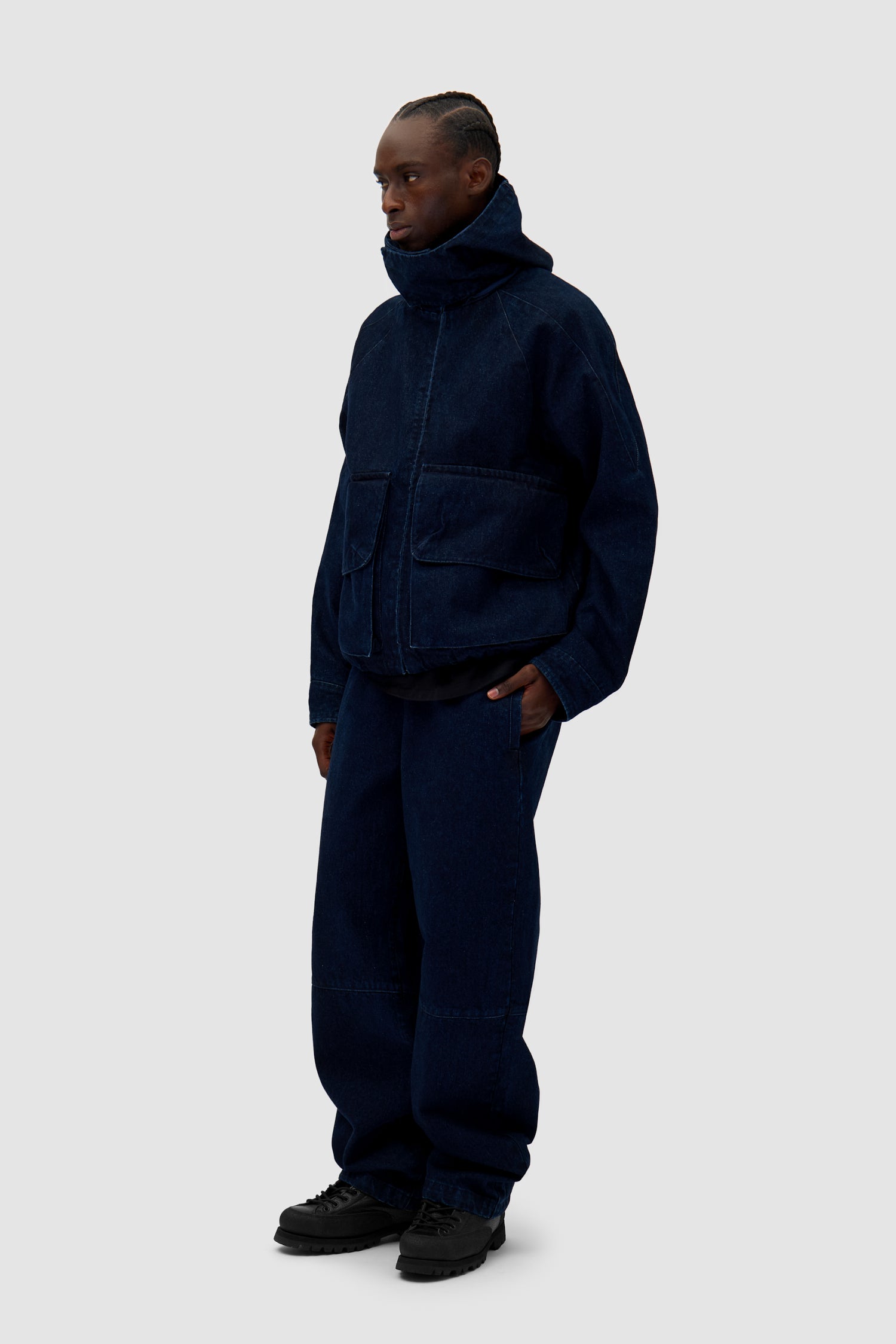 Denim Tech jacket in Navy worn by a model, full-body side view