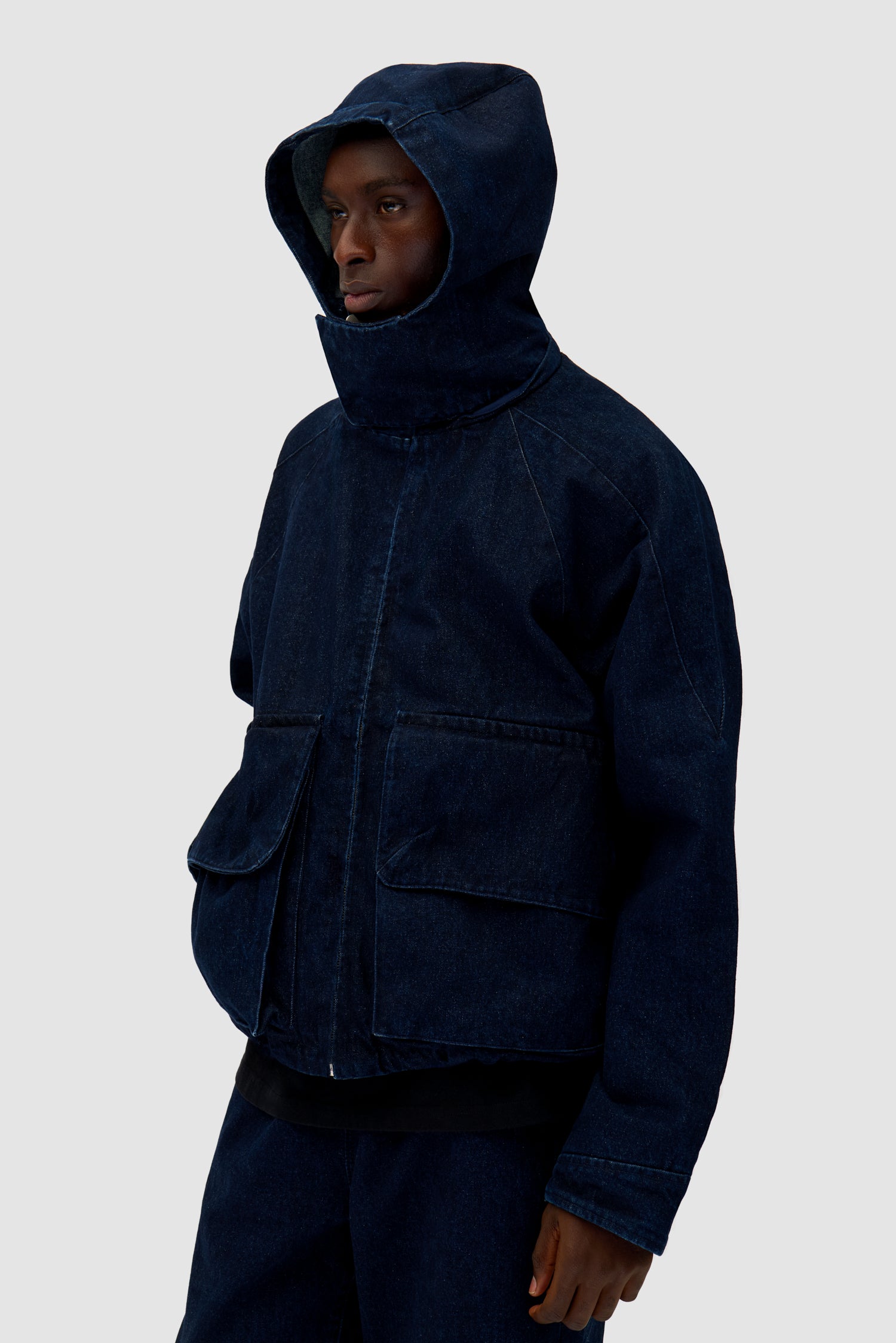Denim Tech jacket in Navy worn by a model, half-body detailed view