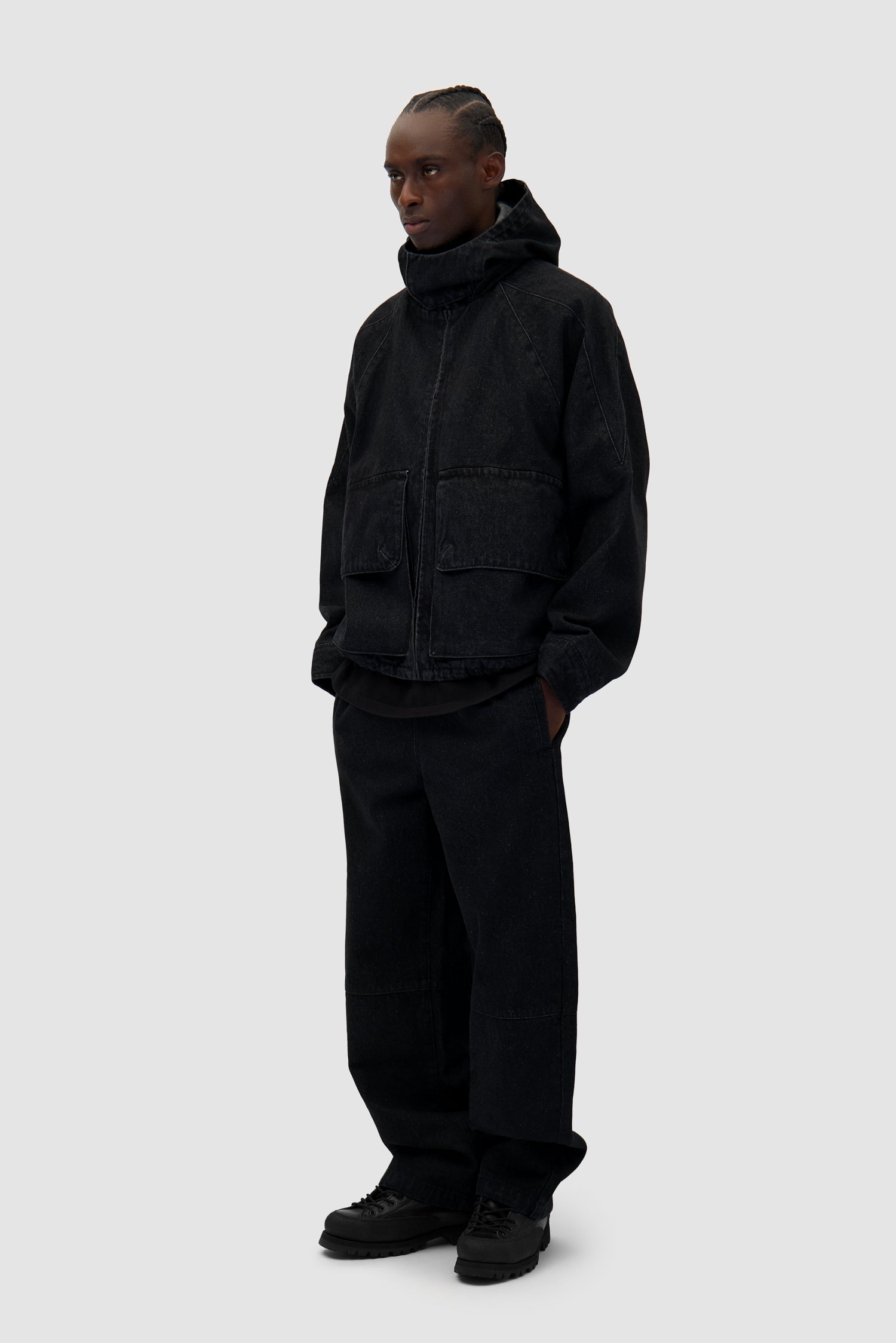 Denim Tech Pants in Black worn by a model, full-body side view