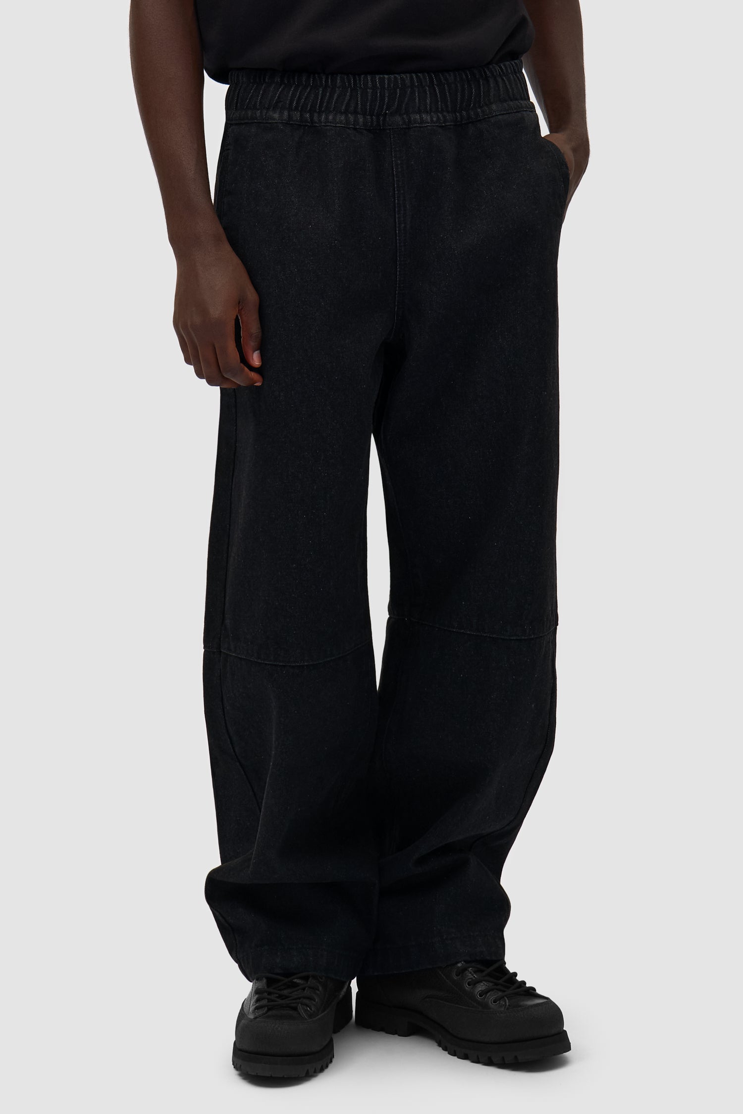 Denim Tech Pants in Black worn by a model, half-body front view