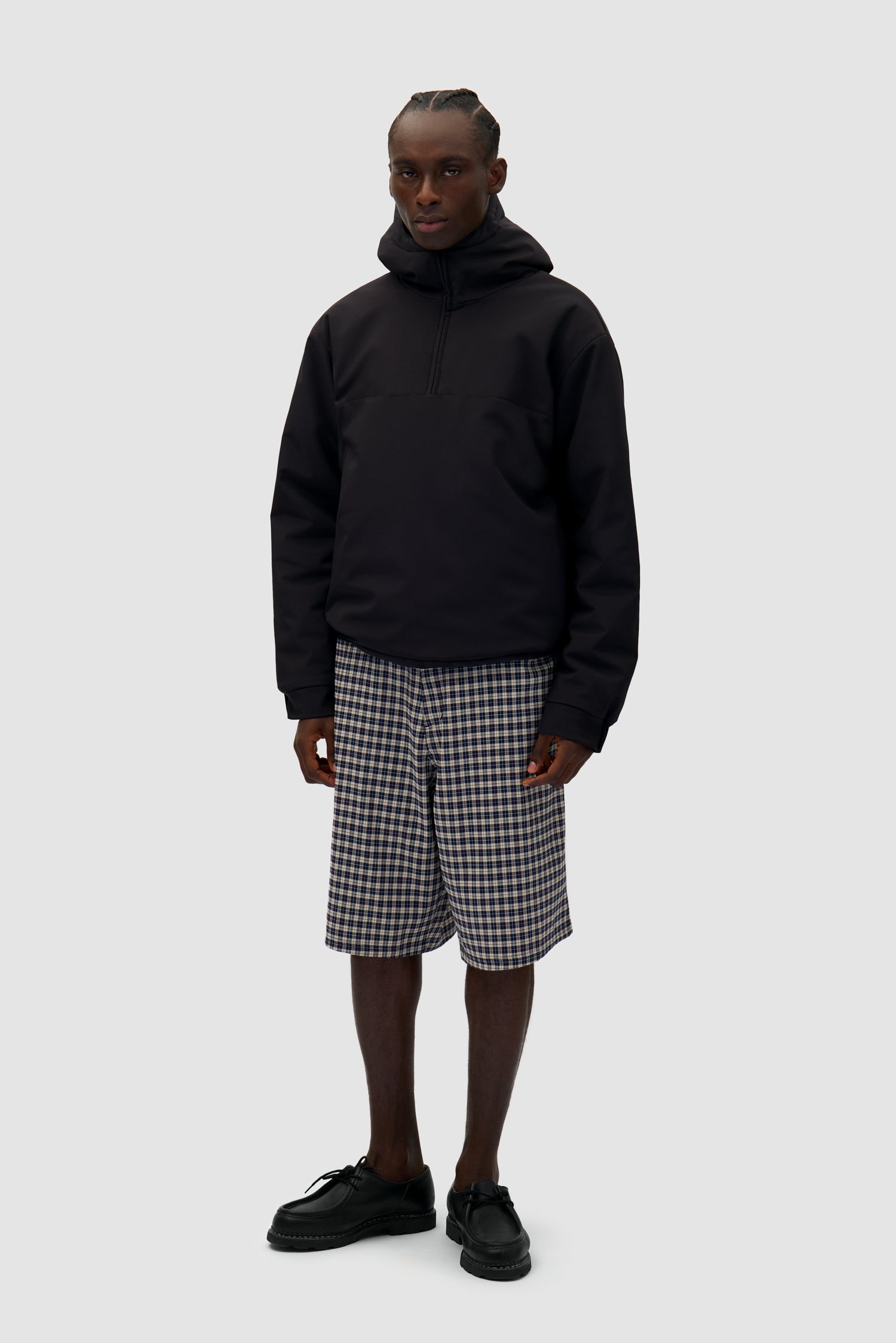 Technical Anorak in Black worn by a model, full-body front view