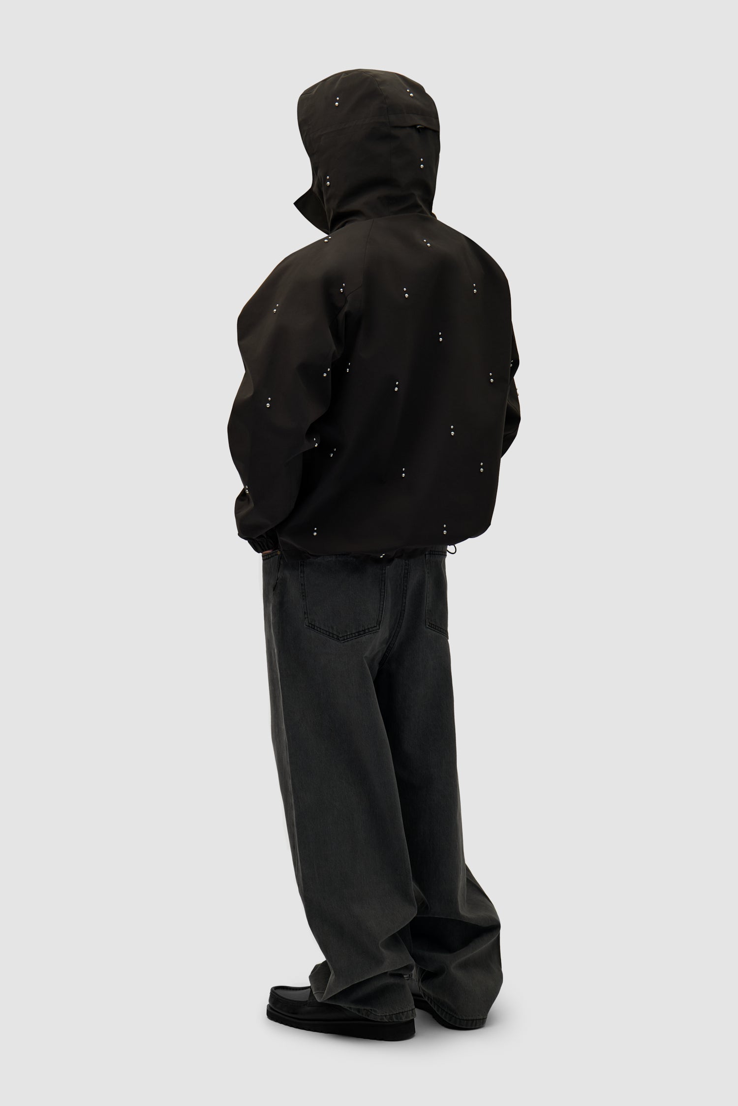 Technical Revits Jacket in Black worn by a model, full-body back view