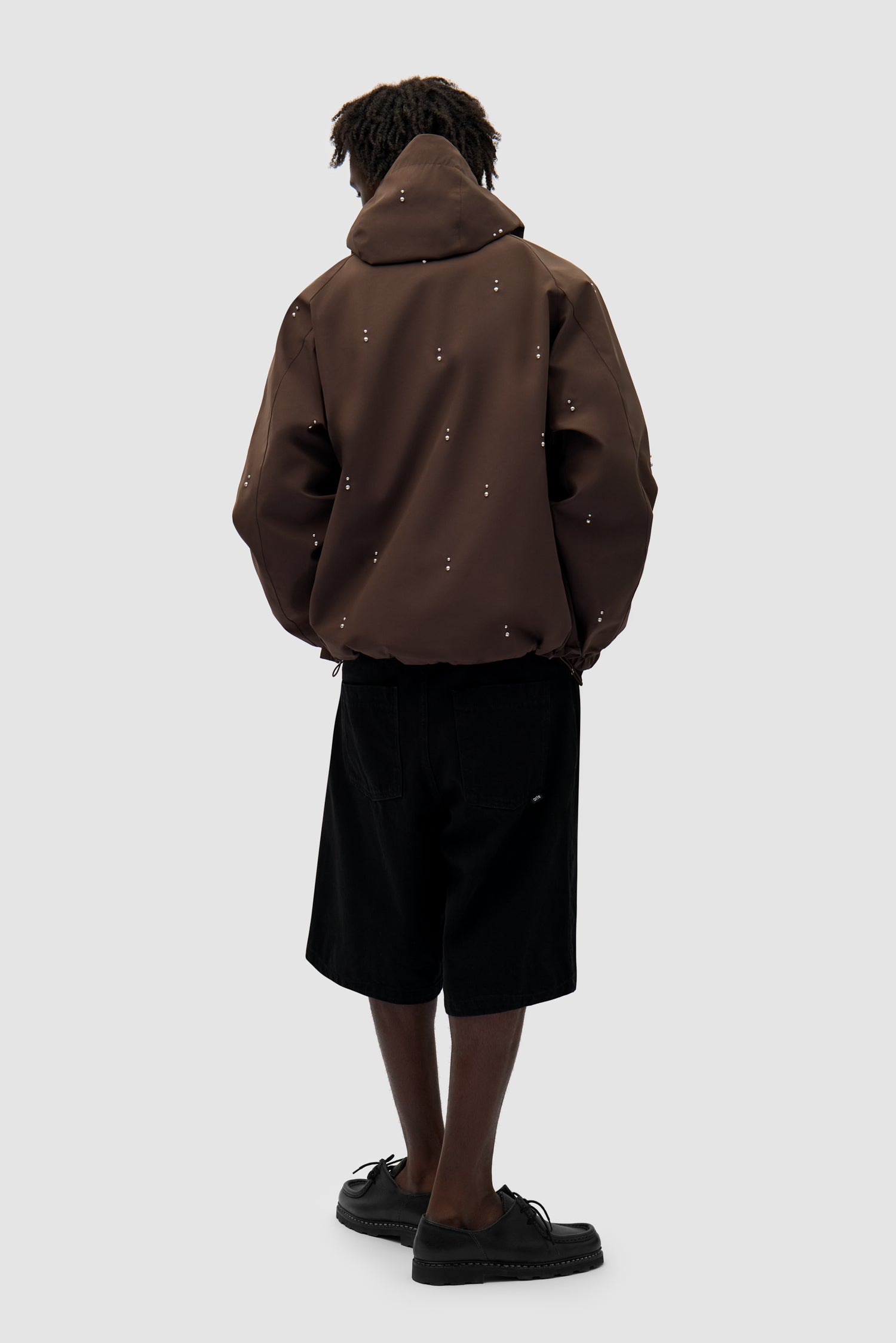Technical Revits Jacket in Brown worn by a model, full-body back view