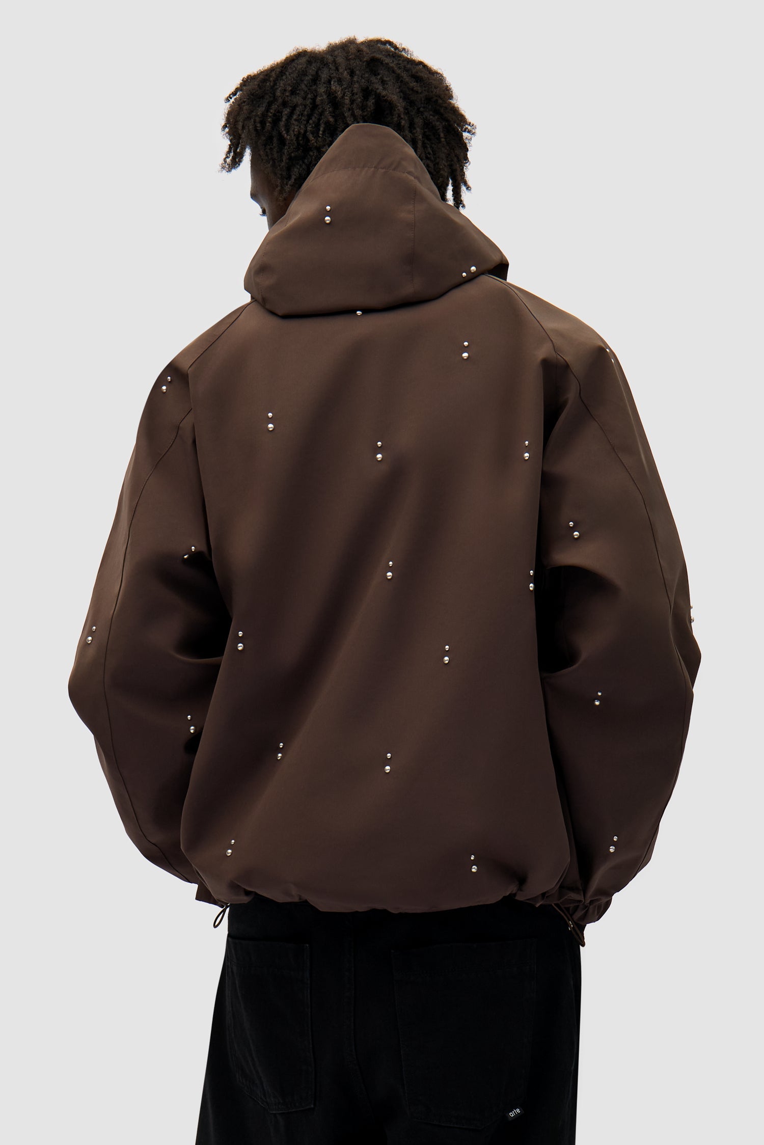 Technical Revits Jacket in Brown worn by a model, half-body back view