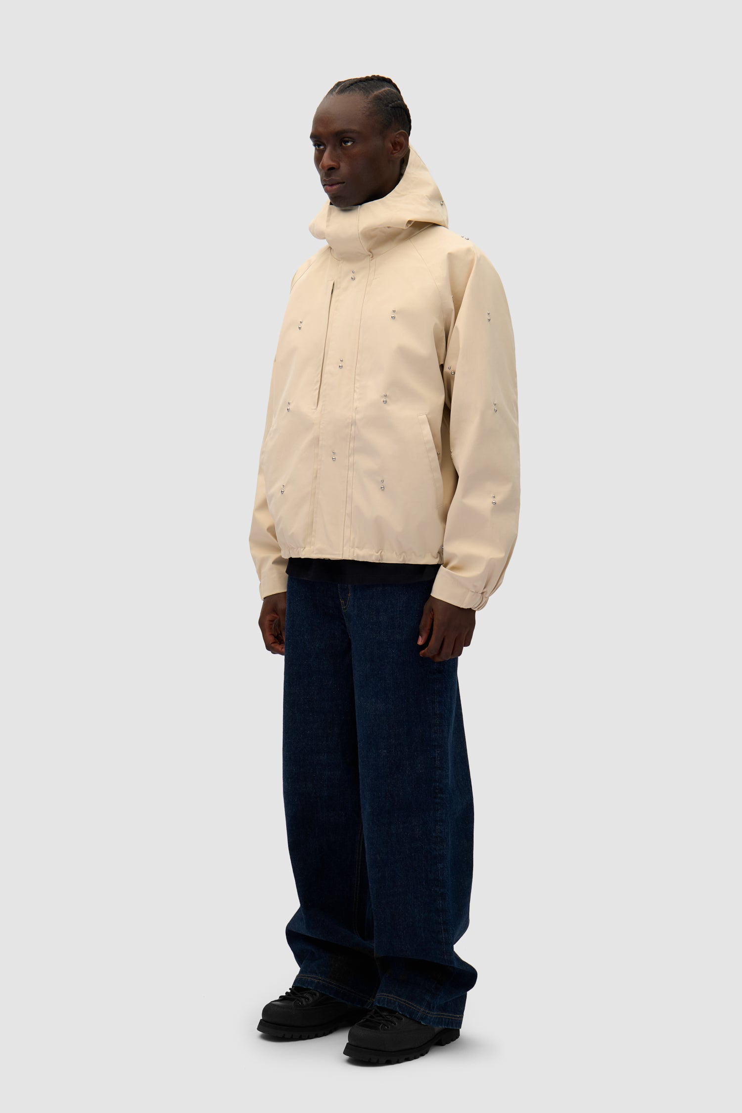 Technical Revits Jacket in Cream worn by a model, full-body side view