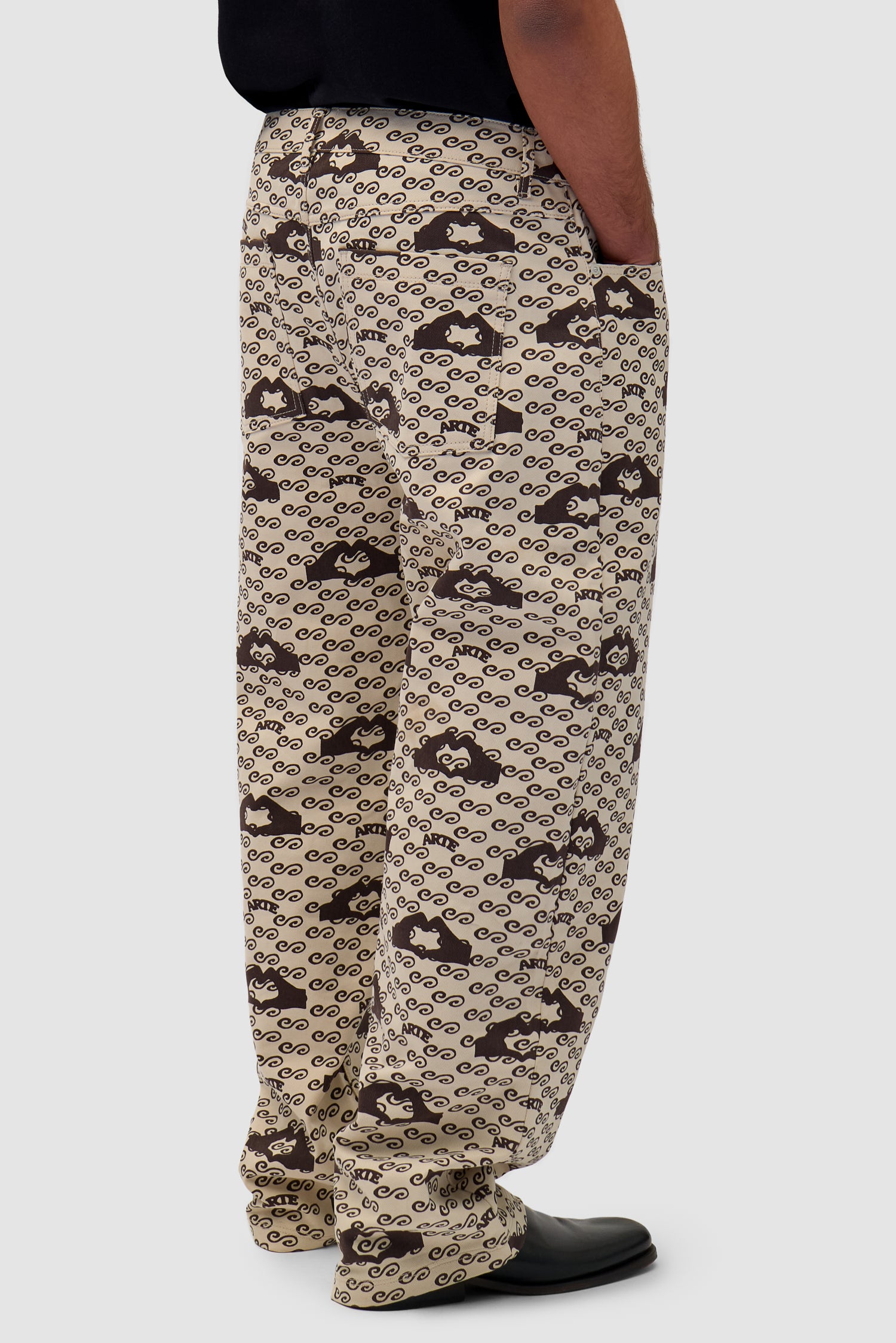 Hand Heart Print Pants in Cream/Brown worn by a model, half-body side view