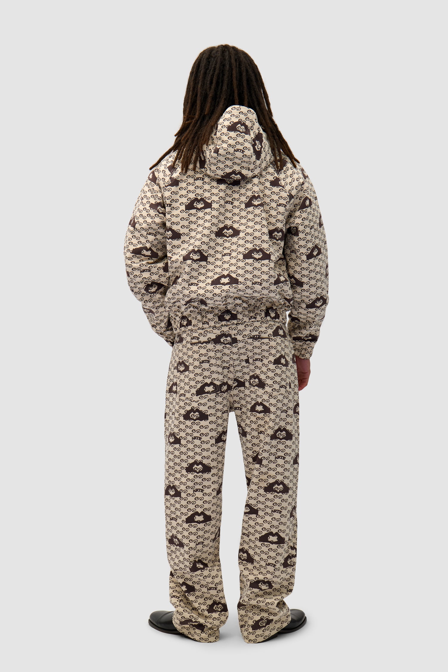 Hand Heart Print Pants in Cream/Brown worn by a model, full-body back view