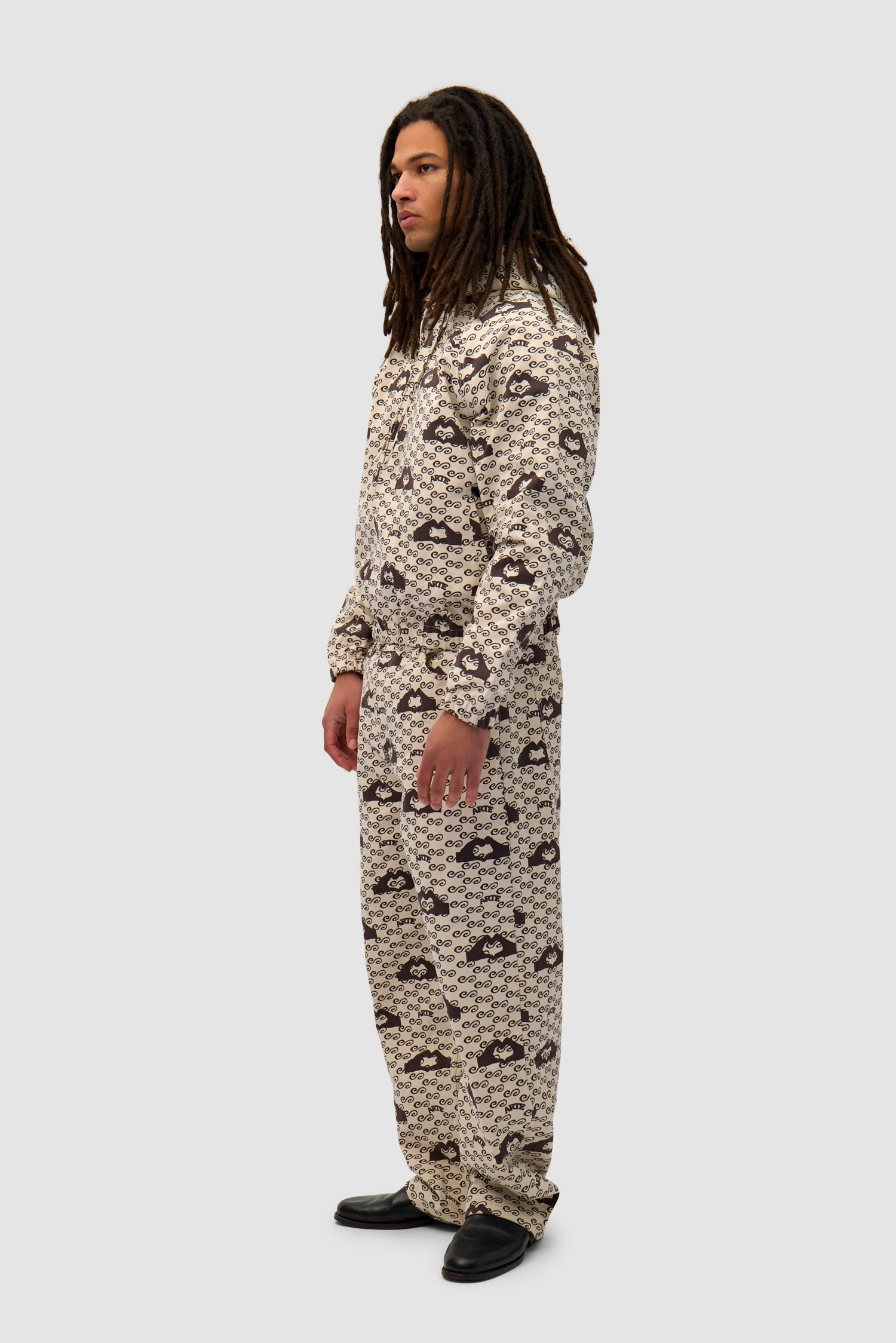 Hand Heart Print Pants in Cream/Brown worn by a model, full-body side view