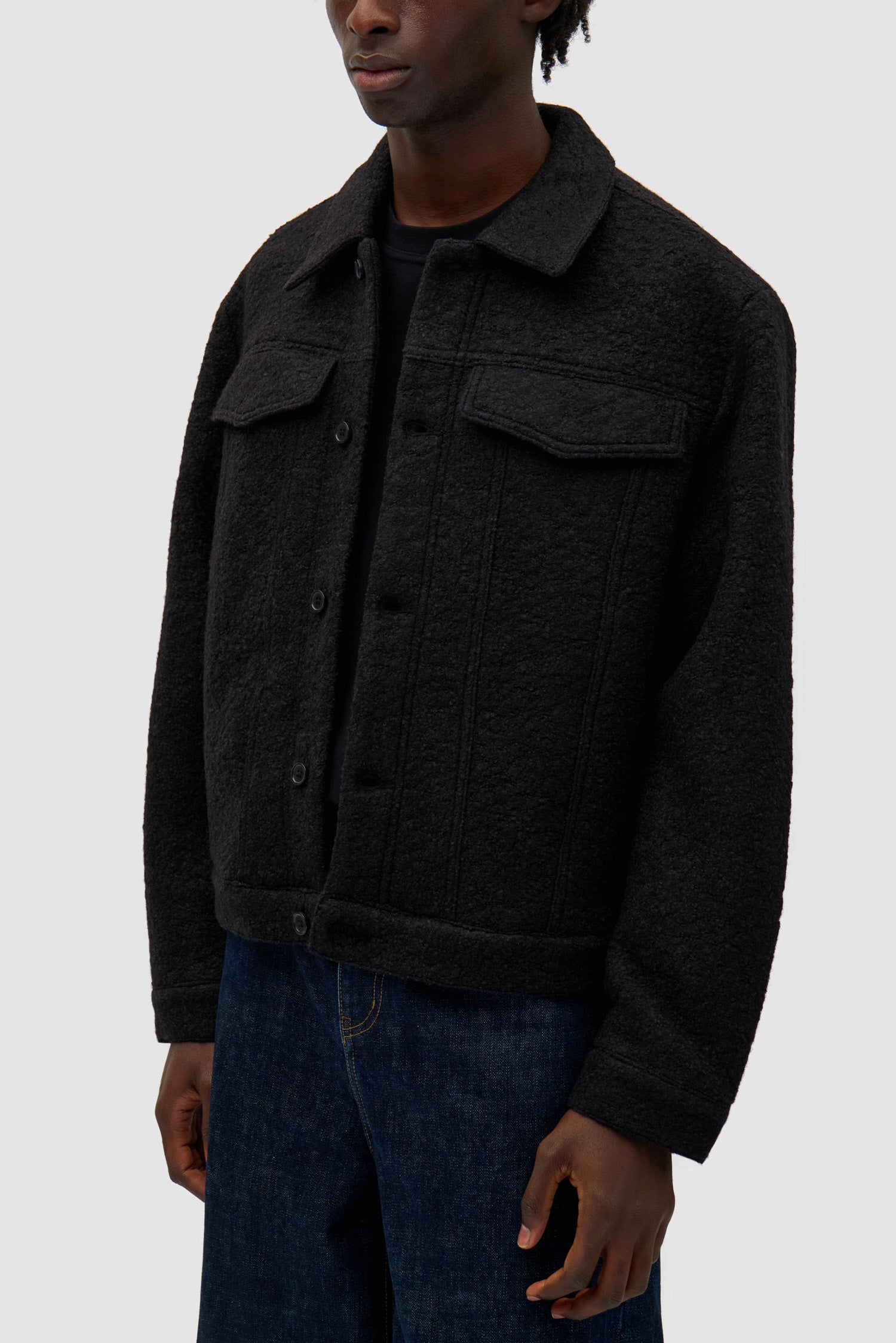Wool Jacket in Black worn by a model, full-body back view