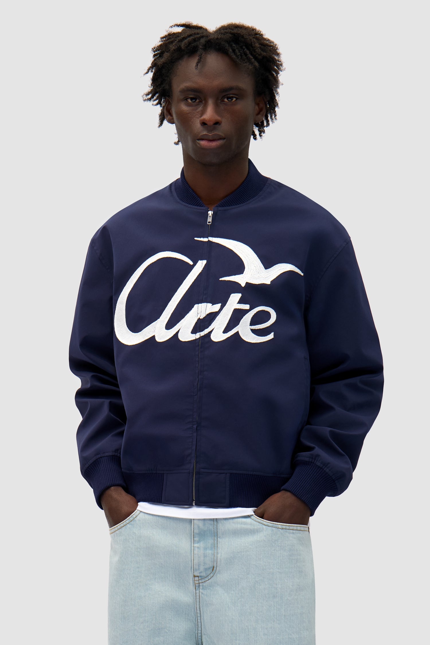 Logo Bird Bomber Jacket in Navy worn by a model, half-body front view