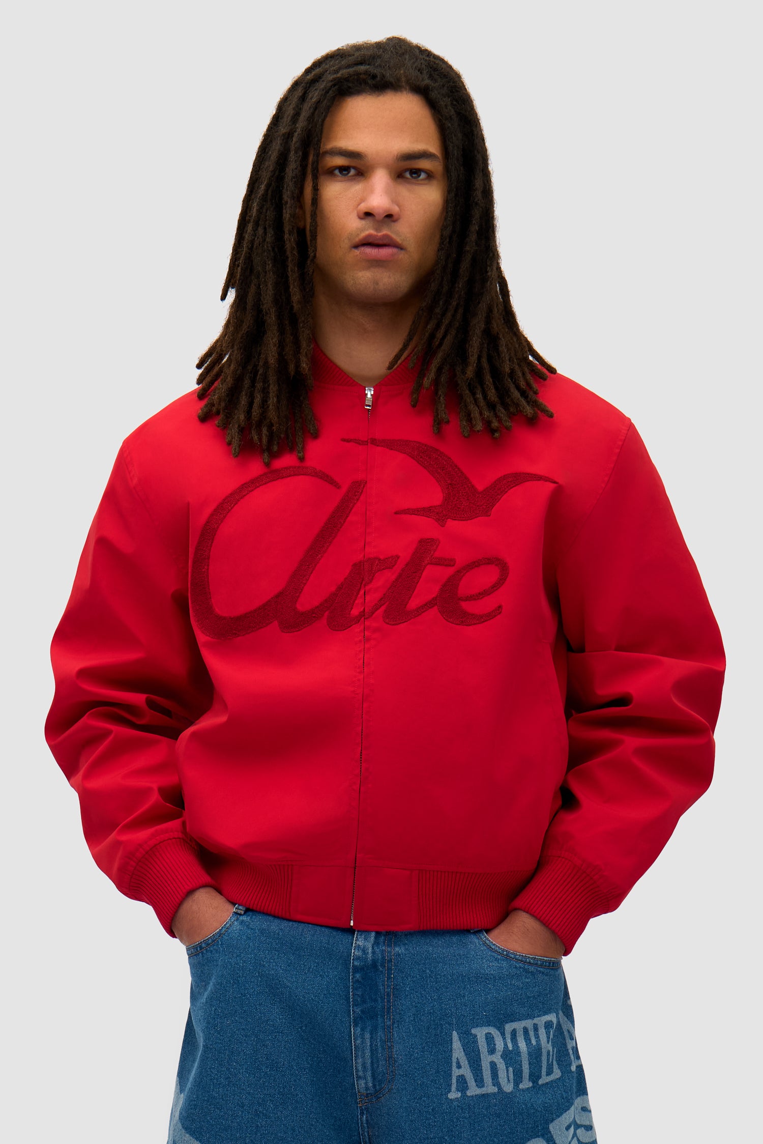 Logo Bird Bomber Jacket in Red worn by a model, half-body front view