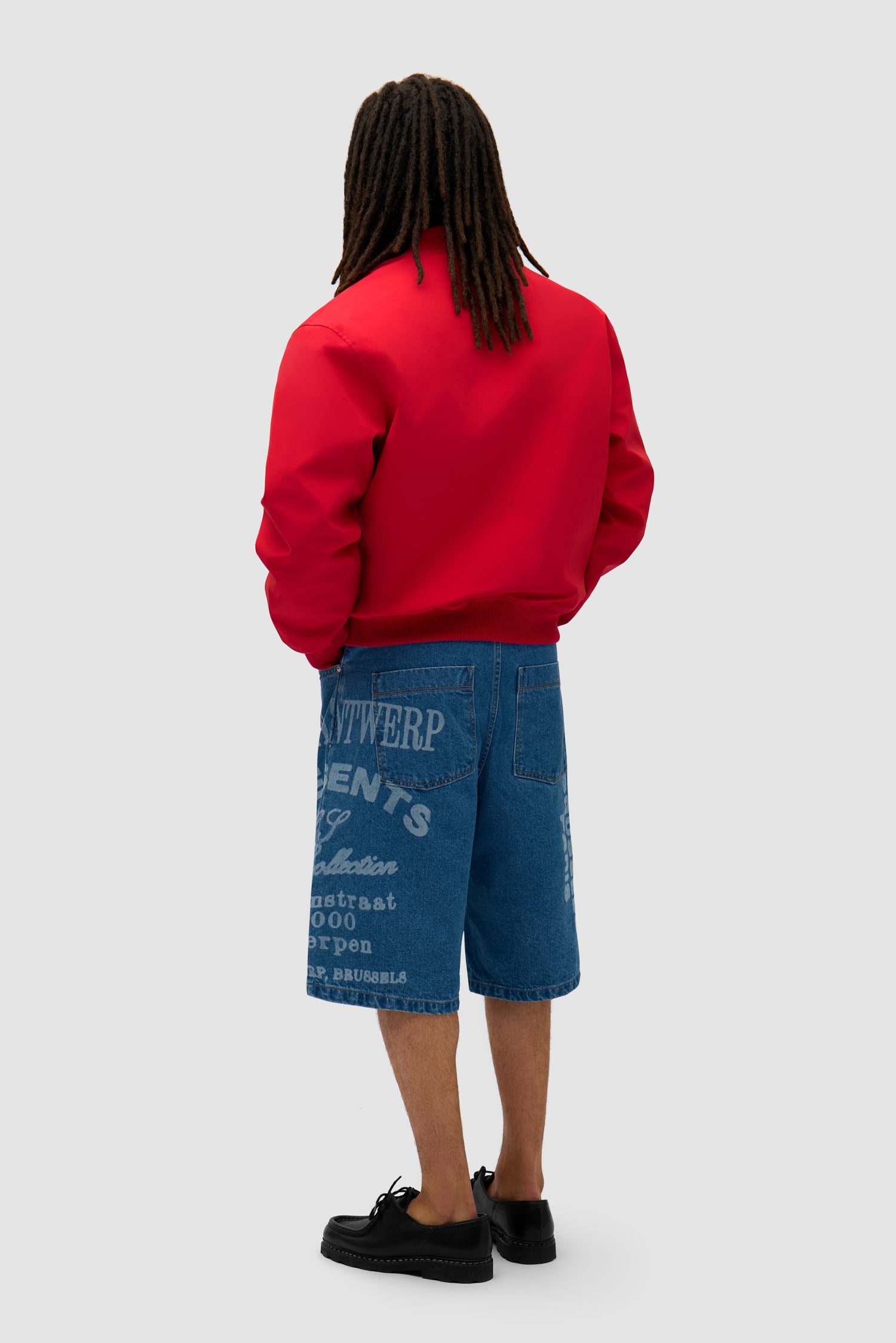 Logo Bird Bomber Jacket in Red worn by a model, full-body back view