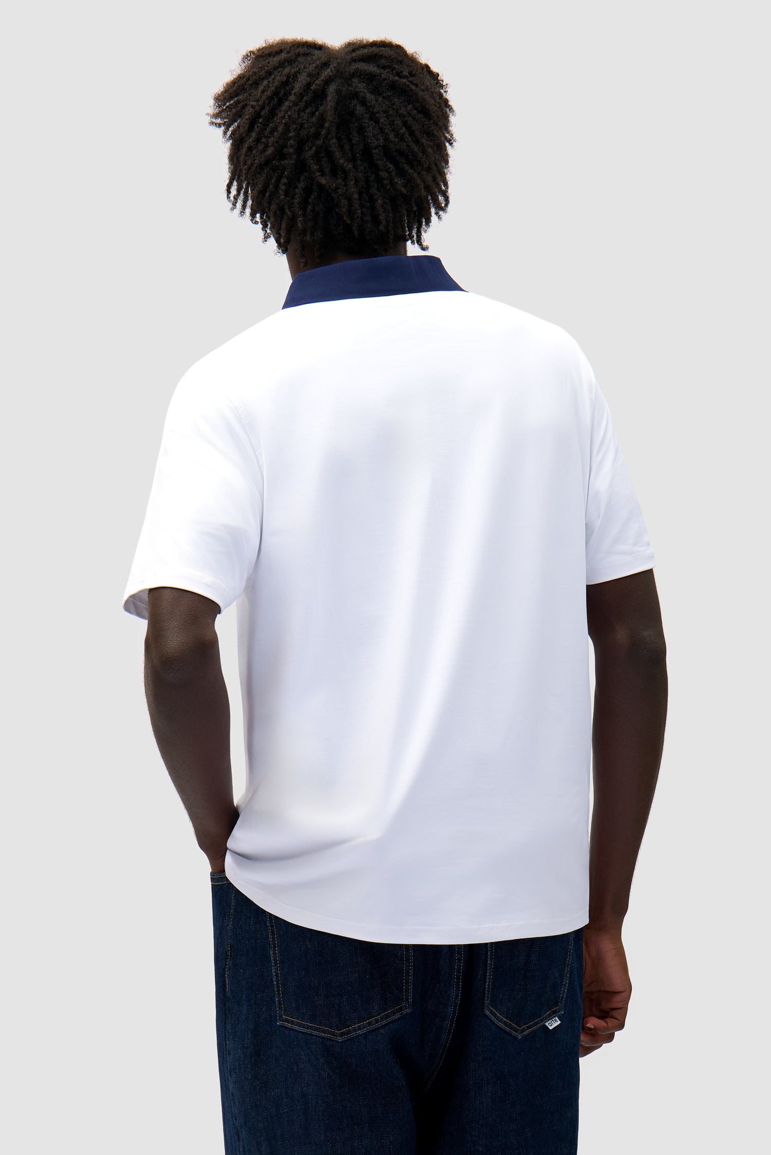 Logo Collar T-shirt in White/Navy worn by a model, half-body back view