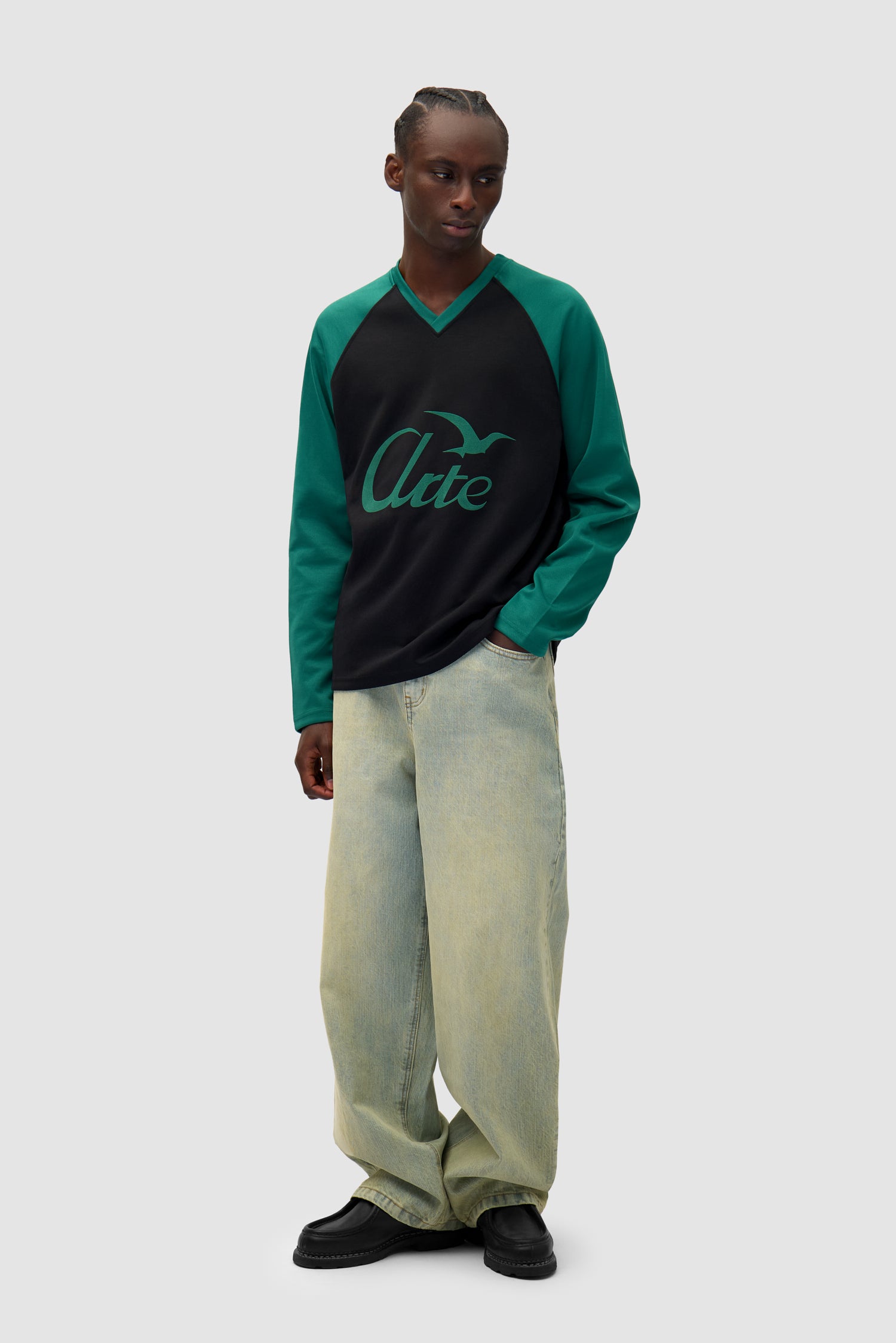 Bird Logo Longsleeve in Green/Black worn by a model, full-body front view