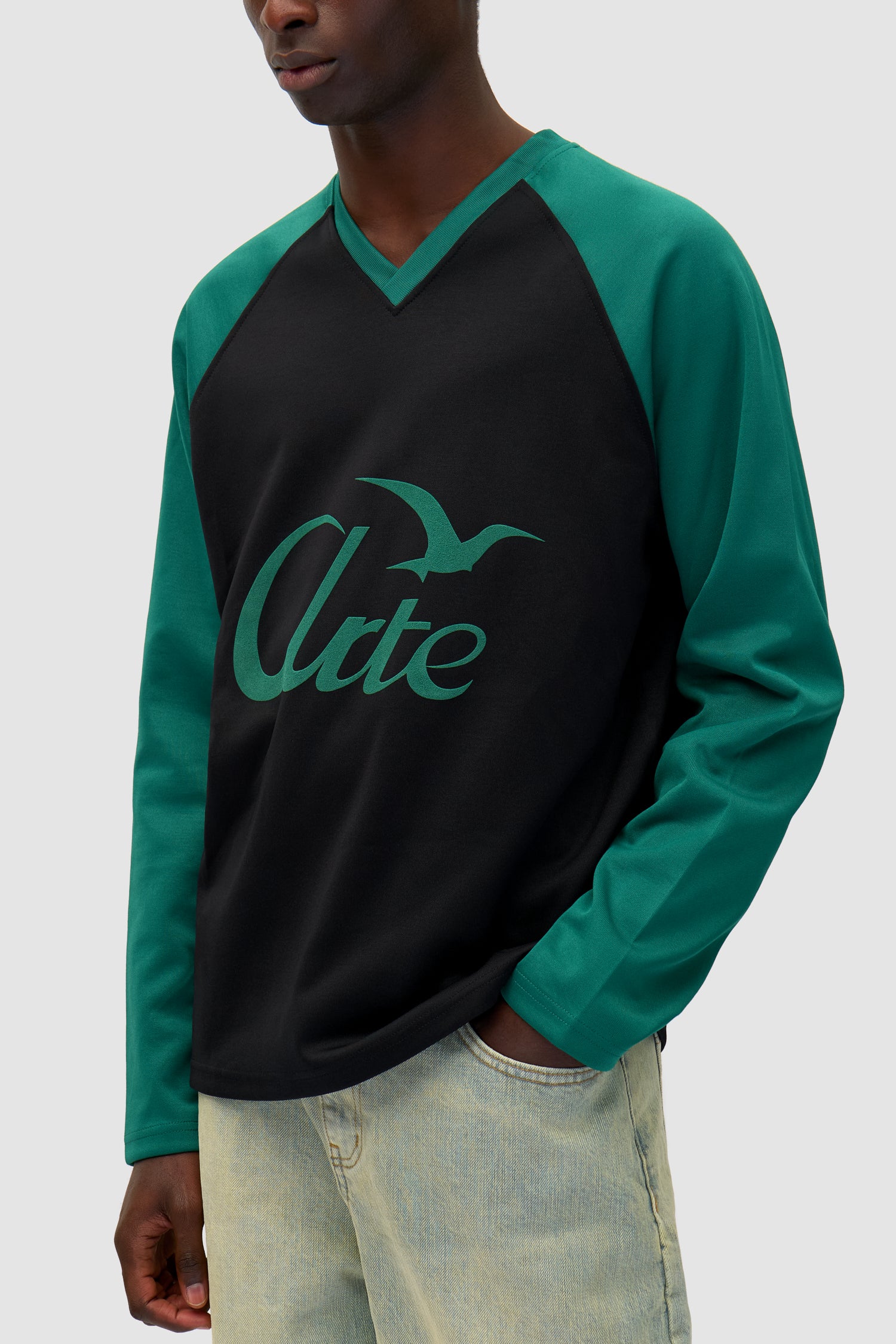 Bird Logo Longsleeve in Green/Black worn by a model, full-body back view