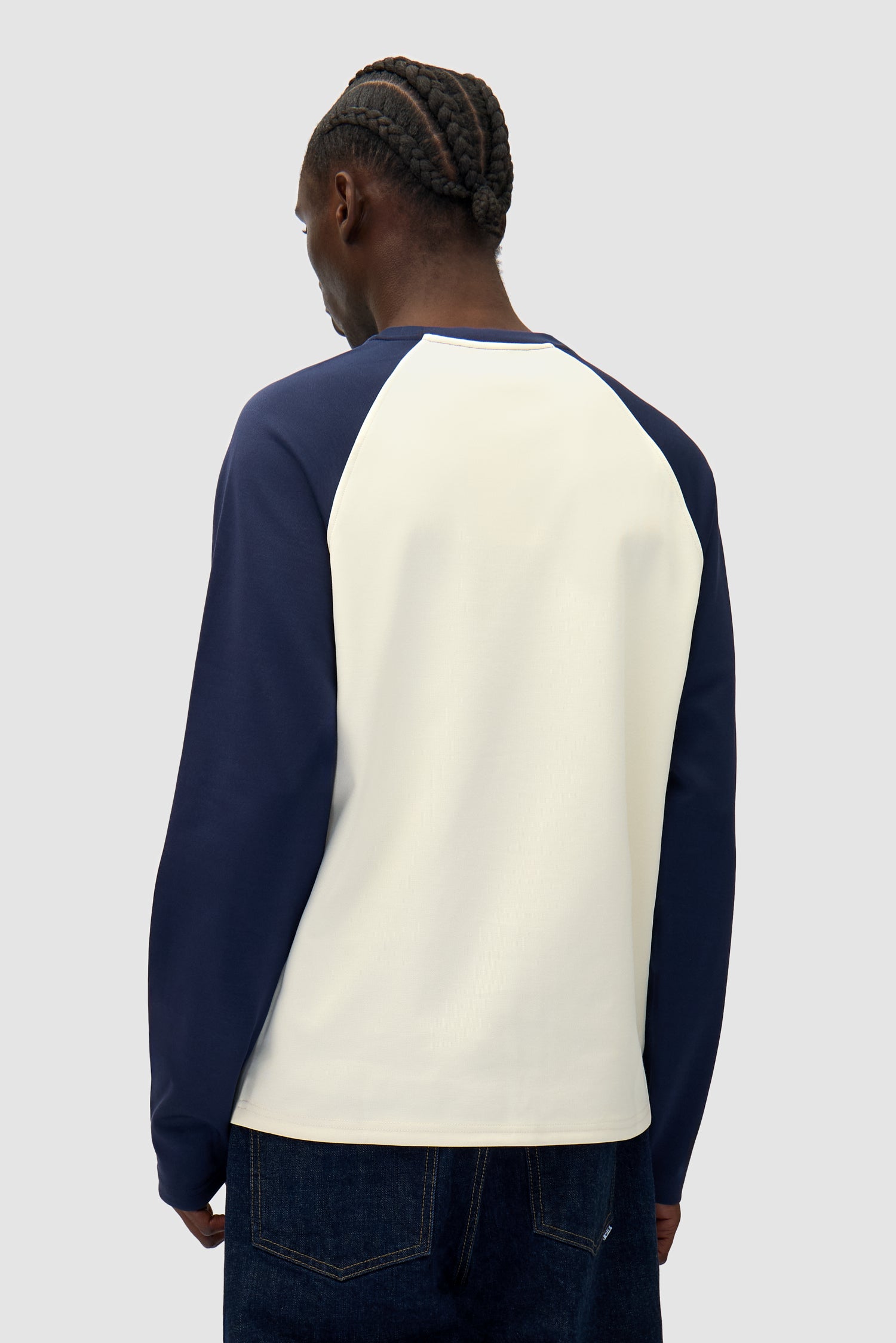 Bird Logo Longsleeve in Navy/Cream worn by a model, half-body back view