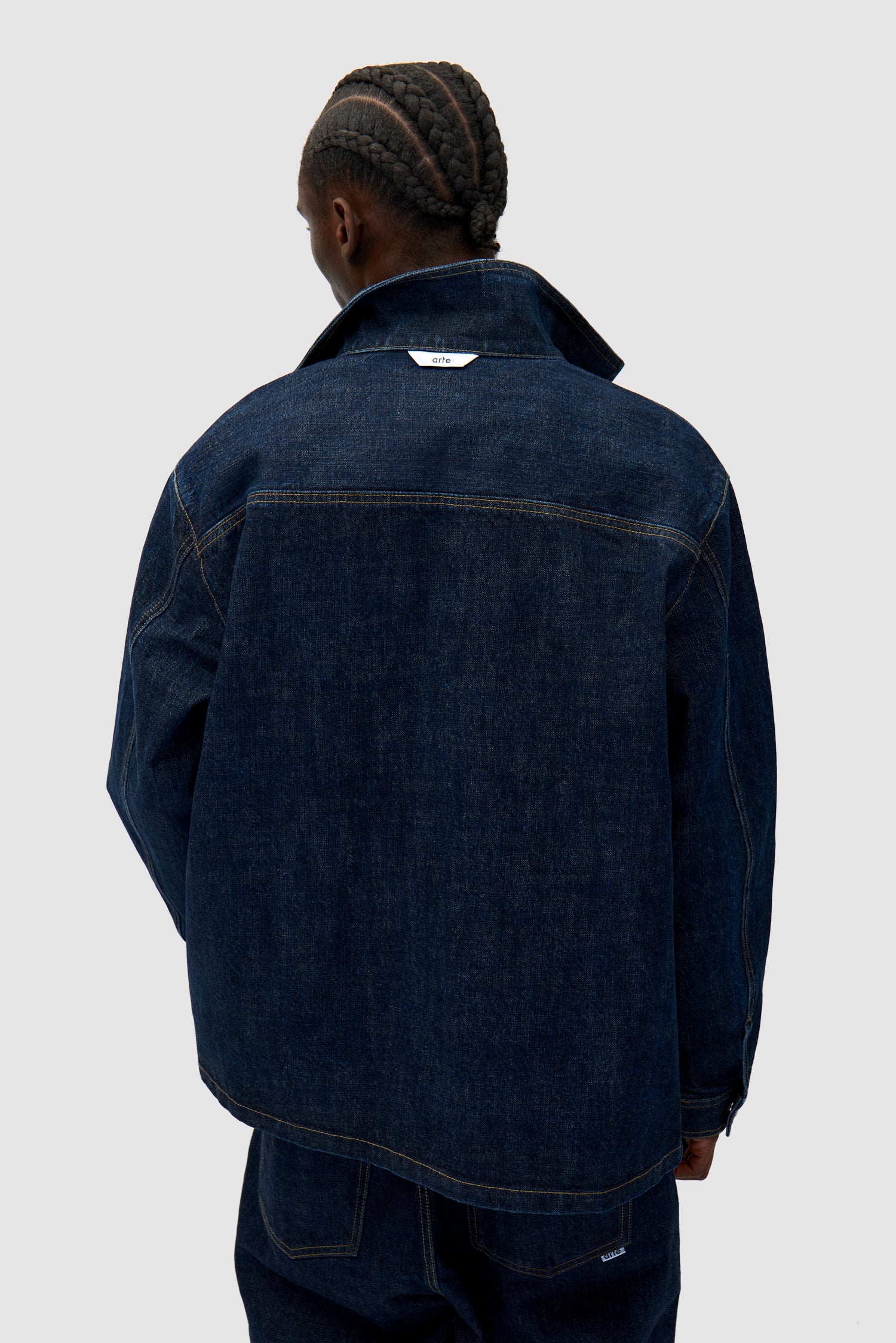 Oversized Denim Shirt in Dark Wash worn by a model, half-body back view