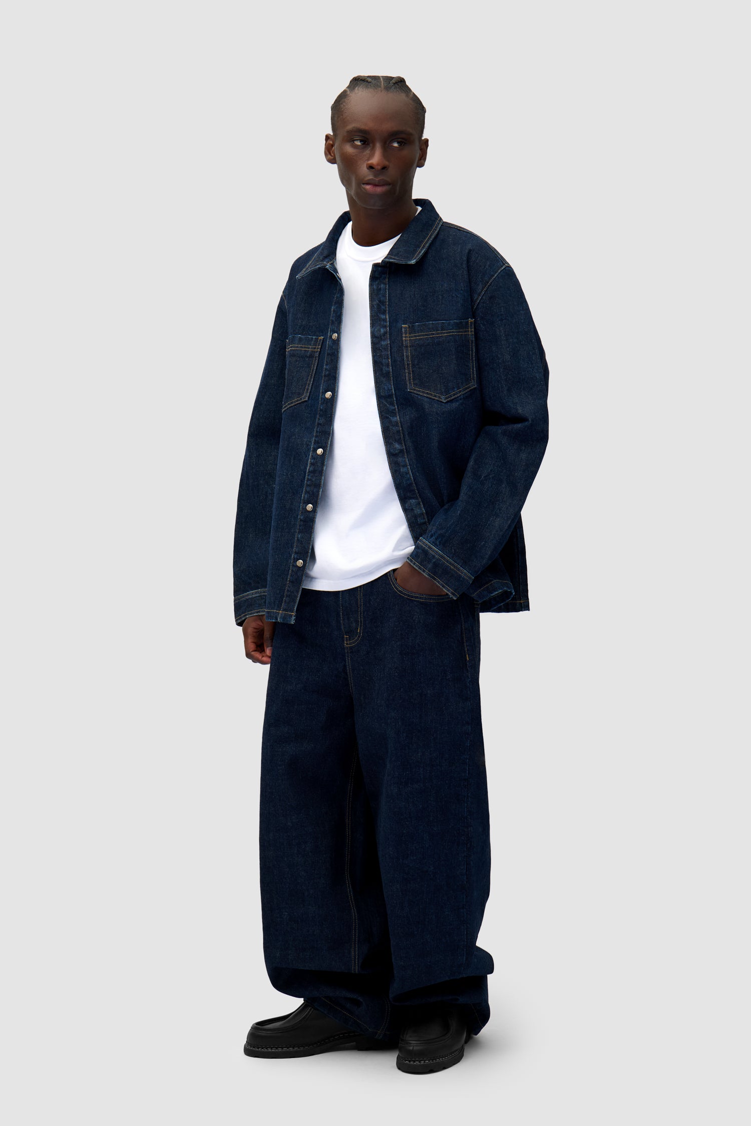 Oversized Denim Shirt in Dark Wash worn by a model, full-body side view
