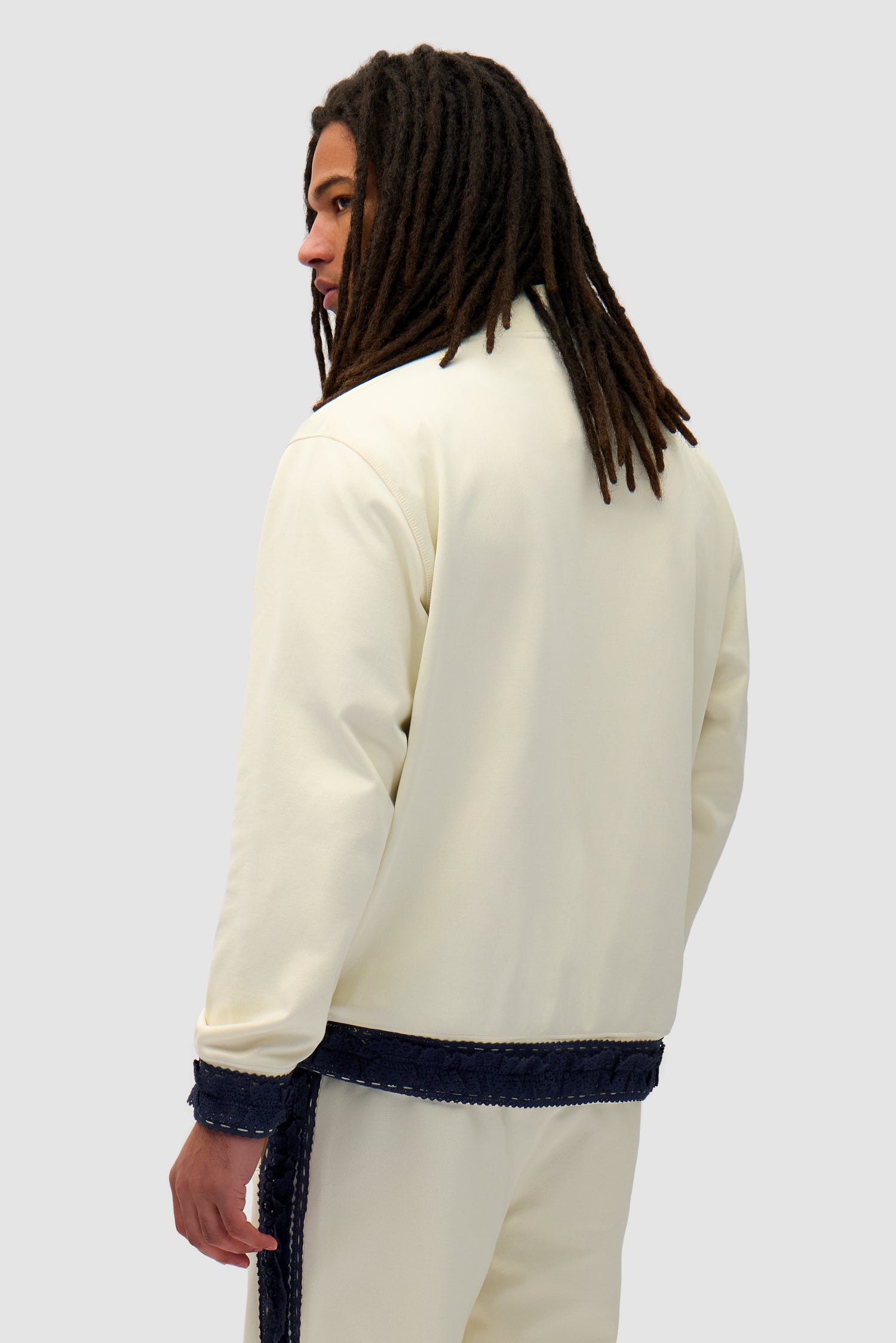 Trim Jacket in Cream worn by a model, half-body back view