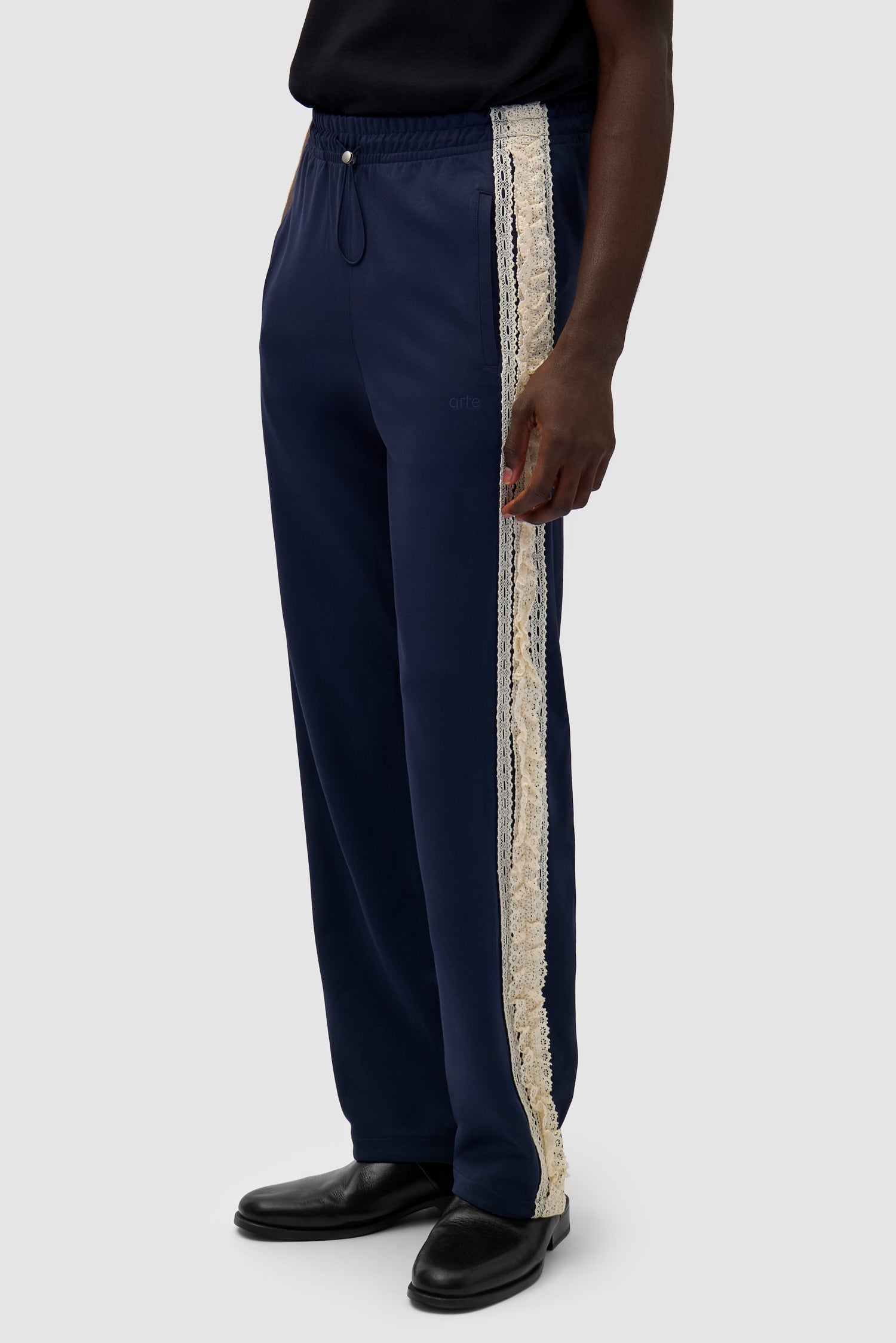 Trim Pants in Navy worn by a model, half-body side view