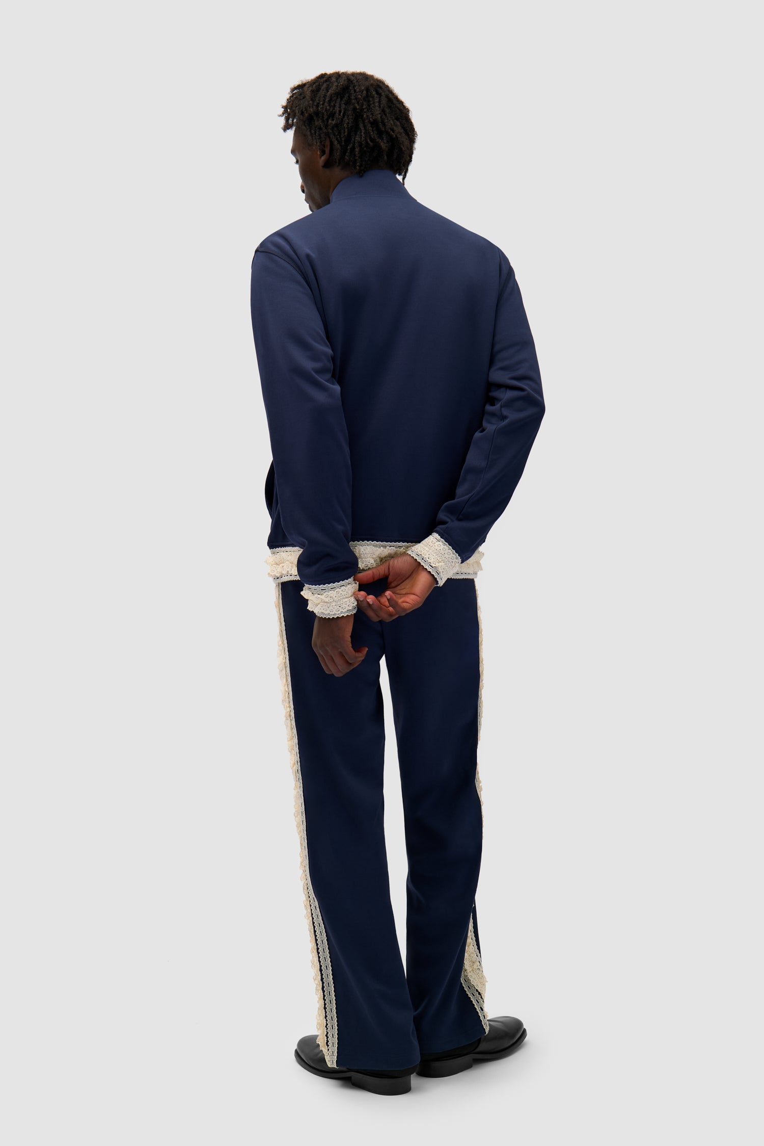 Trim Pants in Navy worn by a model, full-body back view