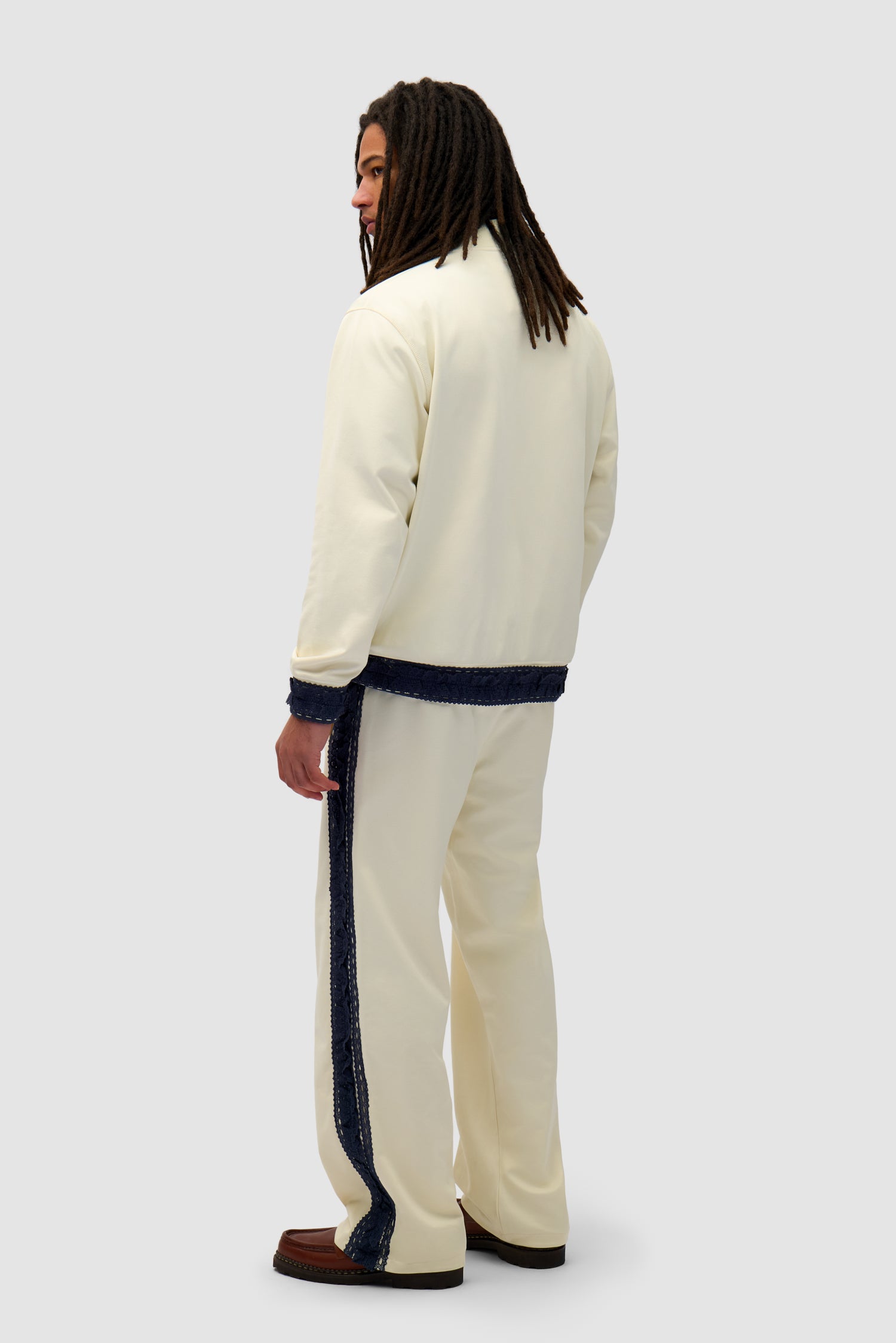 Trim Pants in Cream worn by a model, full-body back view