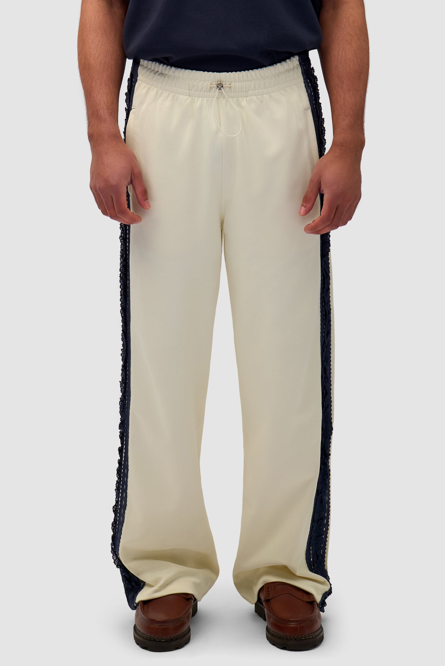 Trim Pants in Cream worn by a model, half-body front view