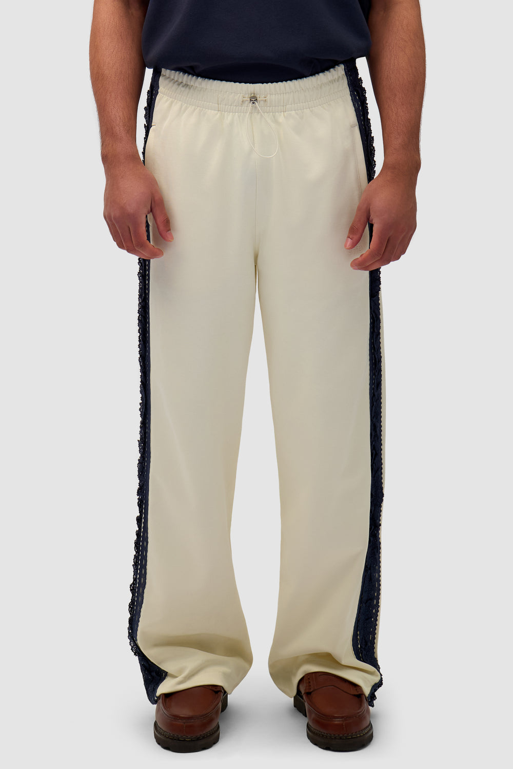 Trim Pants in Cream worn by a model, half-body front view