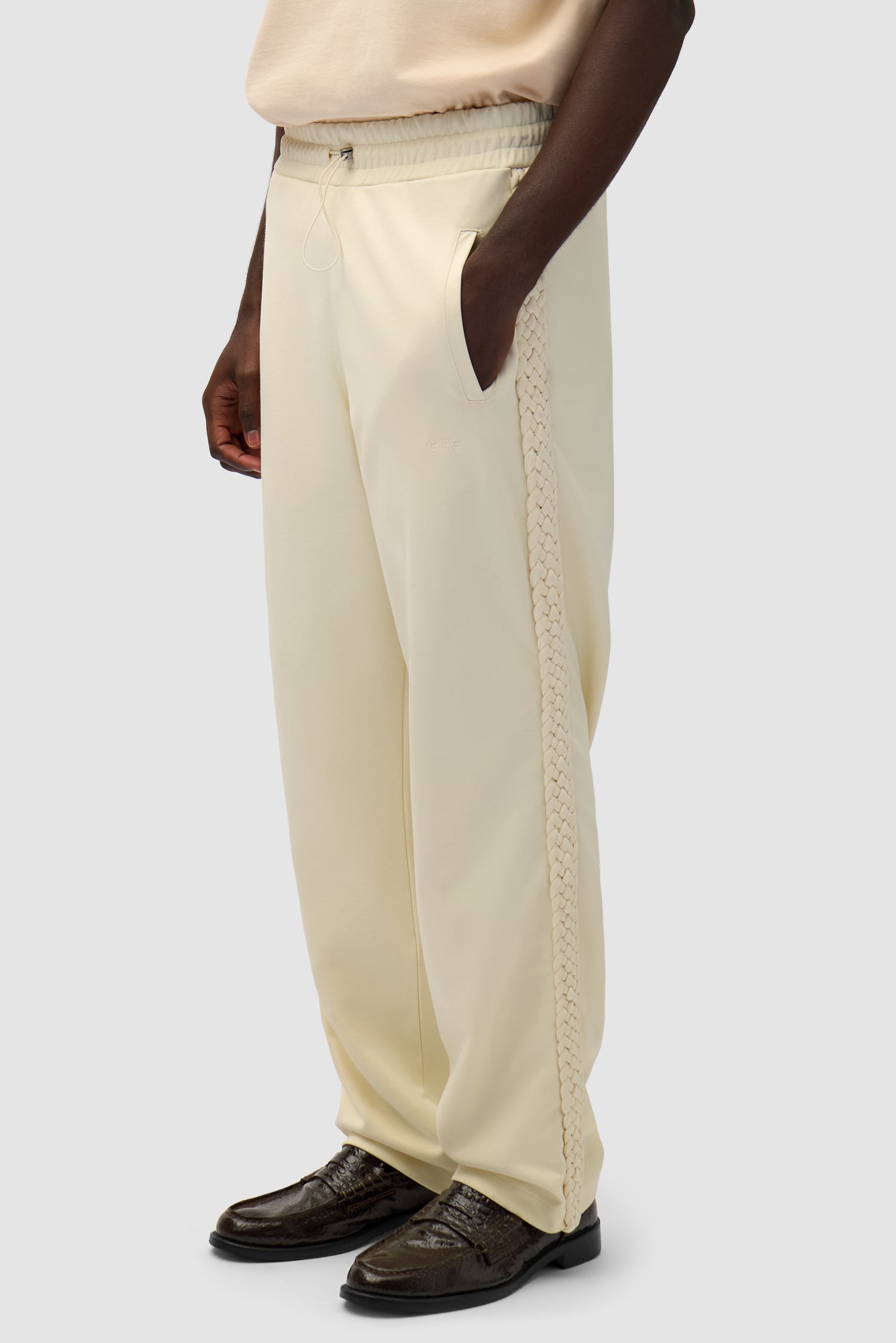 Braid Strip Pants in Cream worn by a model, half-body side view