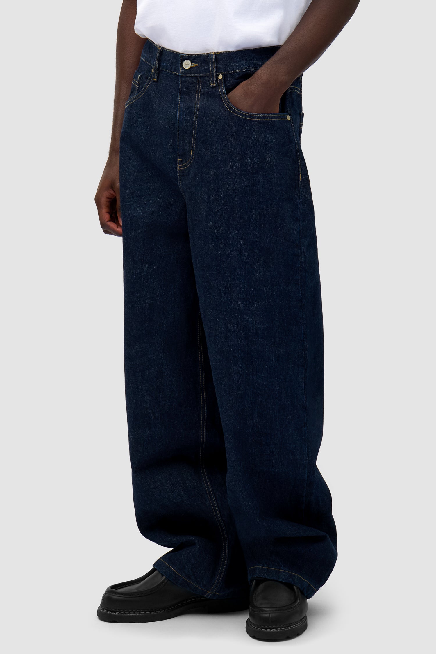 Denim Pants in Dark Wash worn by a model, half-body side view
