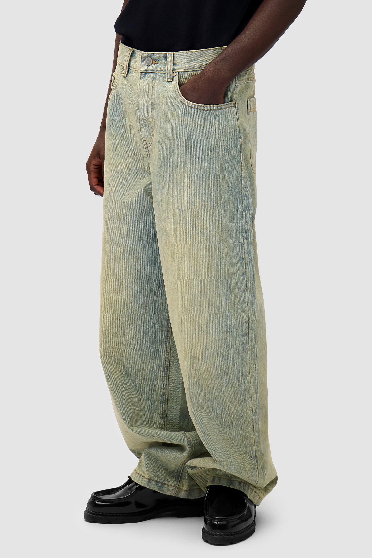 Denim Pants in Dirty Wash worn by a model, half-body side view