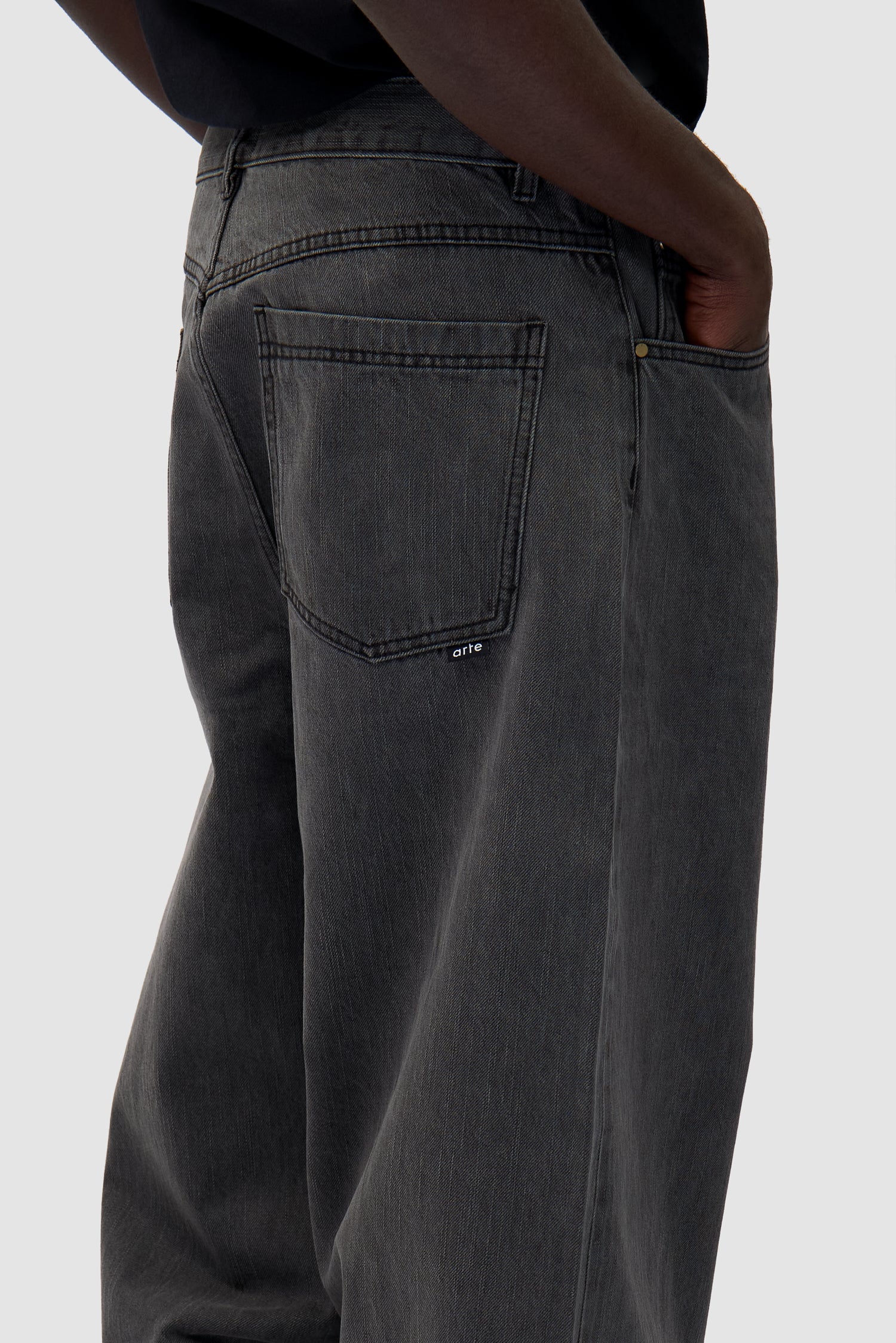 Denim Pants in Fade Black worn by a model, full-body back view