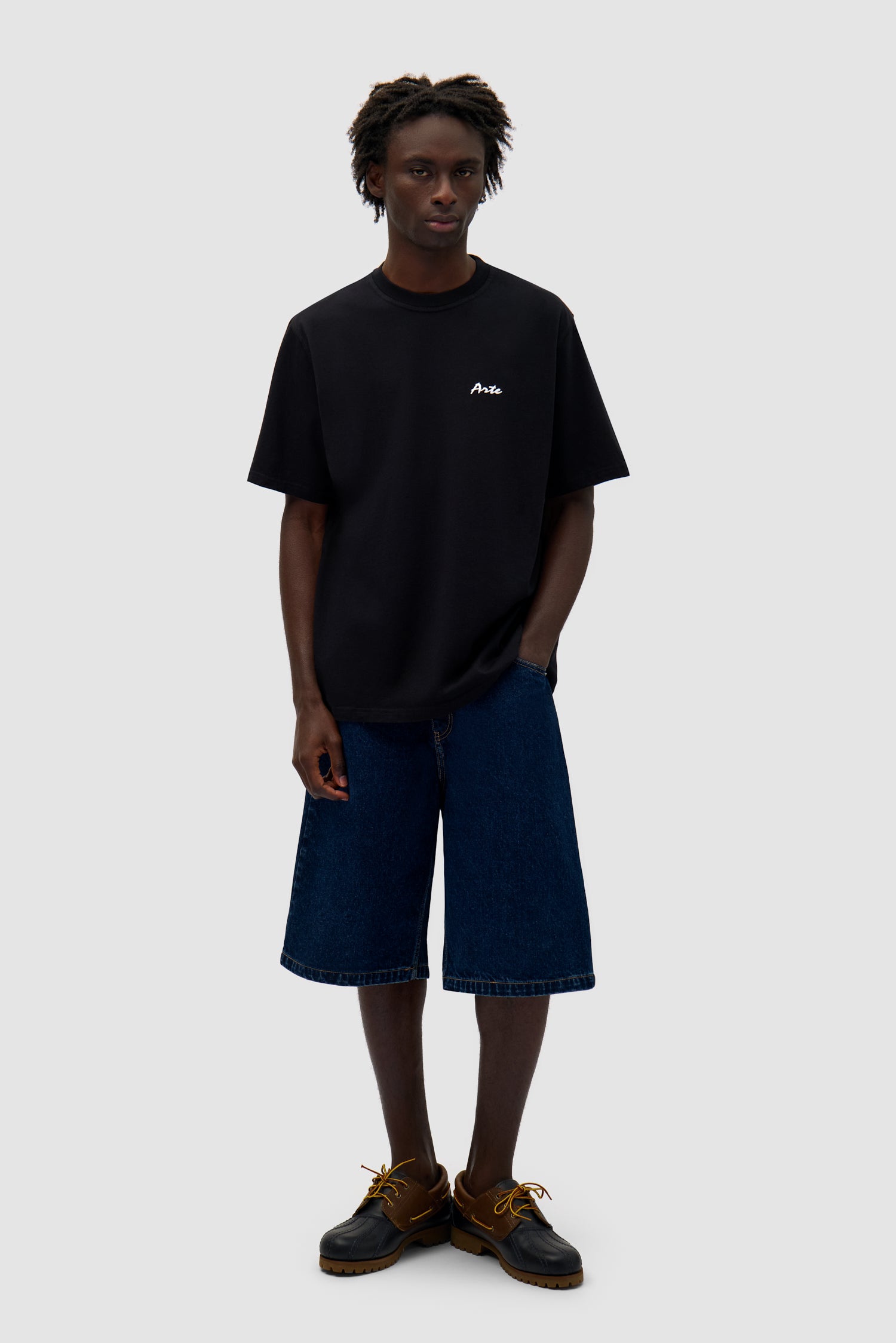 Elements Print T-shirt in Black worn by a model, full-body back view