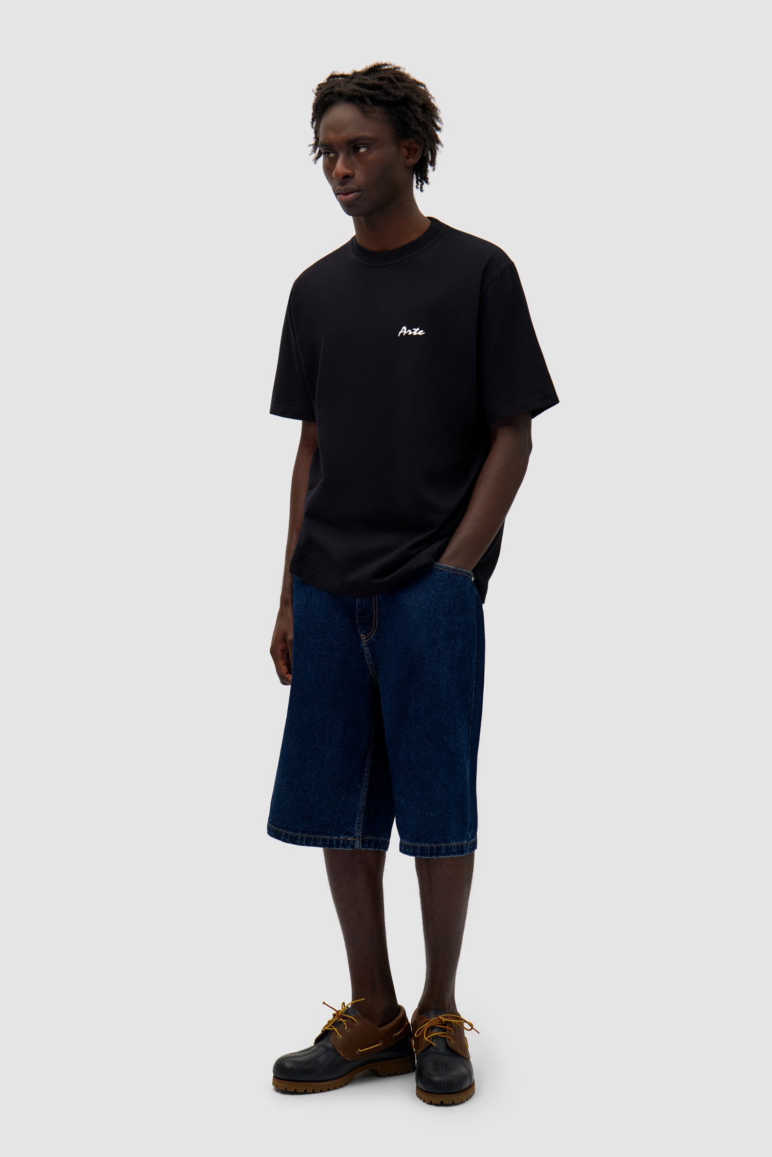 Elements Print T-shirt in Black worn by a model, full-body side view