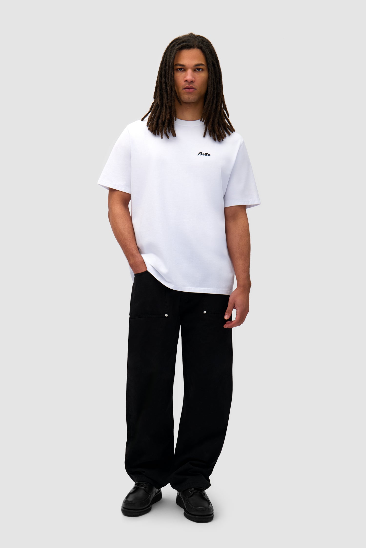 Elements Print T-shirt in White worn by a model, full-body back view