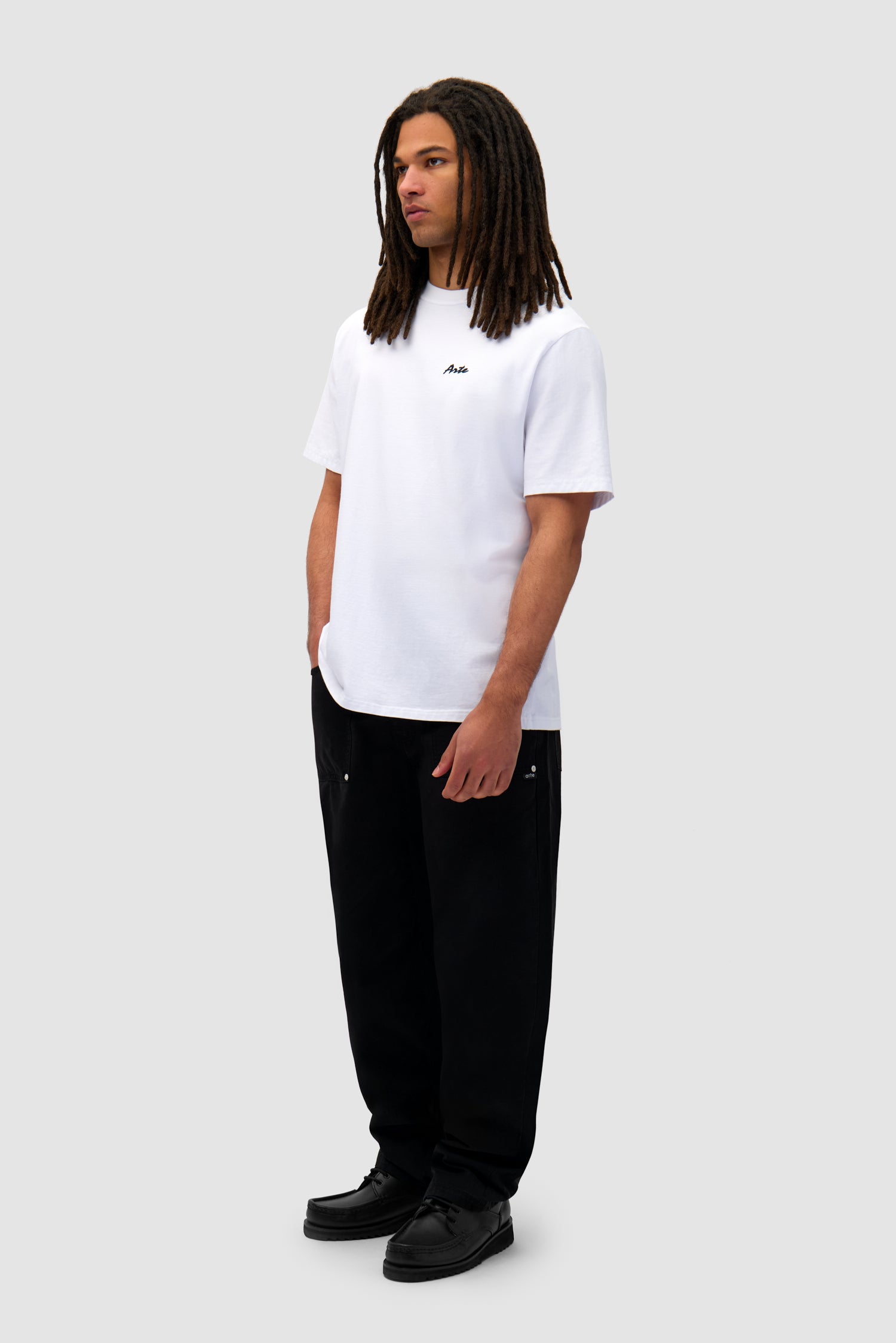 Elements Print T-shirt in White worn by a model, full-body side view