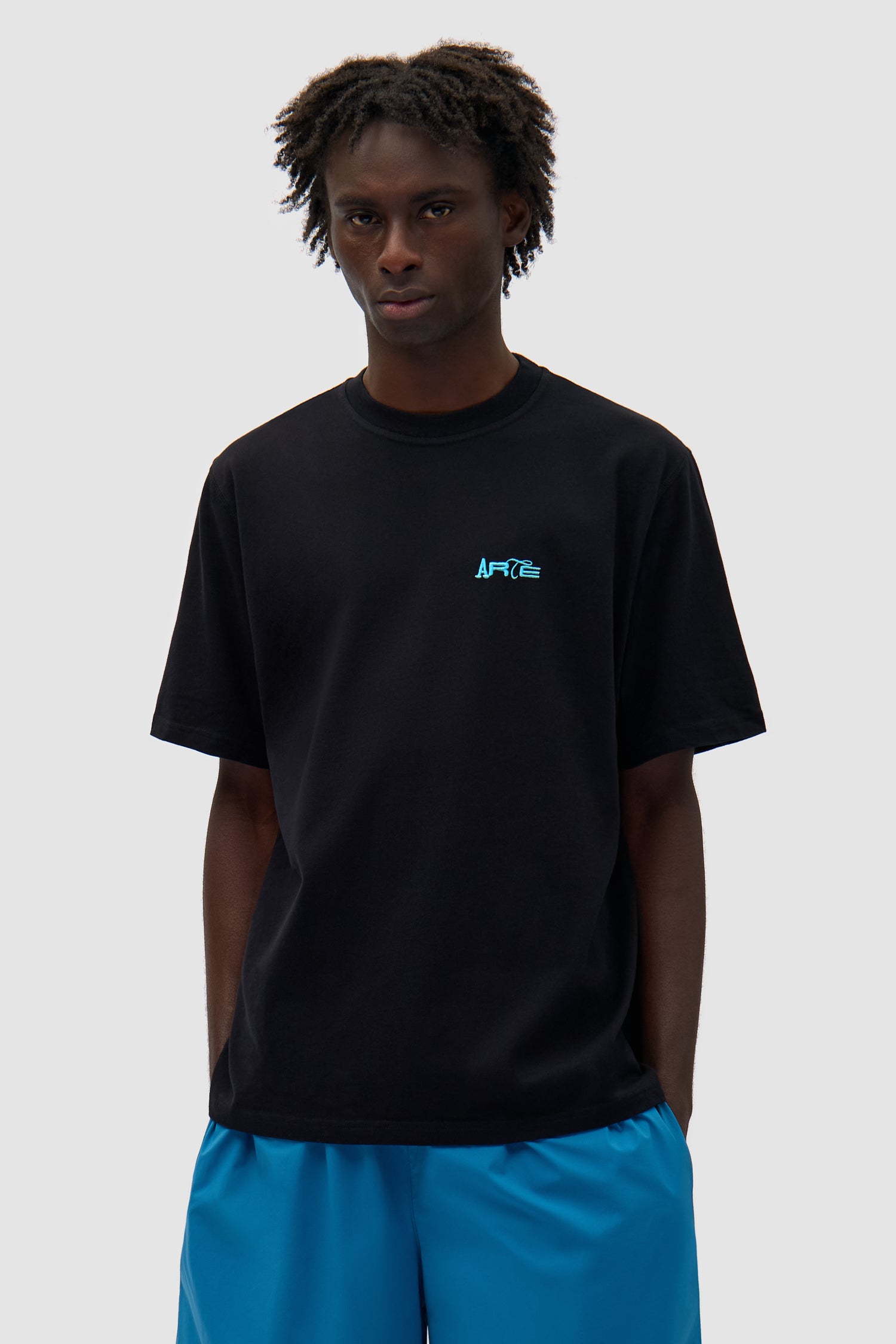 Back Logo People T-shirt in Black worn by a model, half-body front view