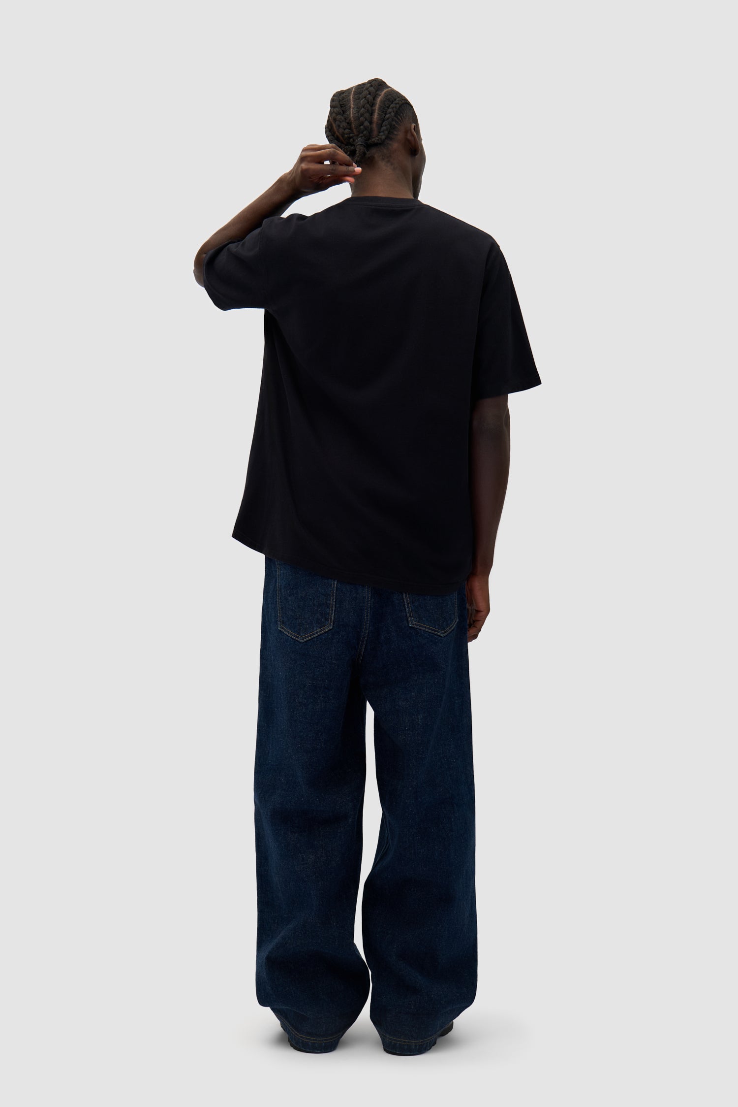 Big Bird Logo T-shirt in Black worn by a model, full-body back view