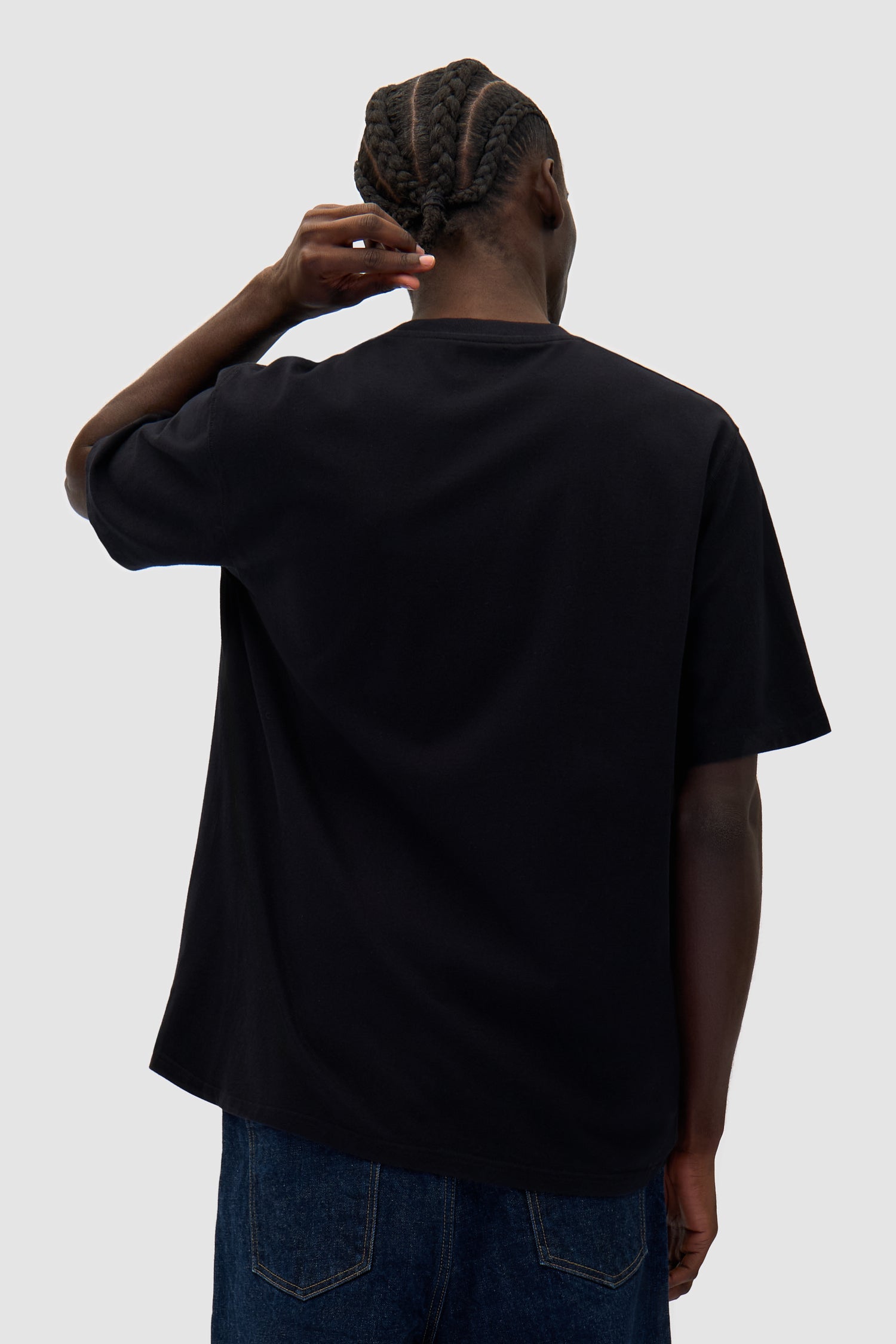 Big Bird Logo T-shirt in Black worn by a model, half-body back view