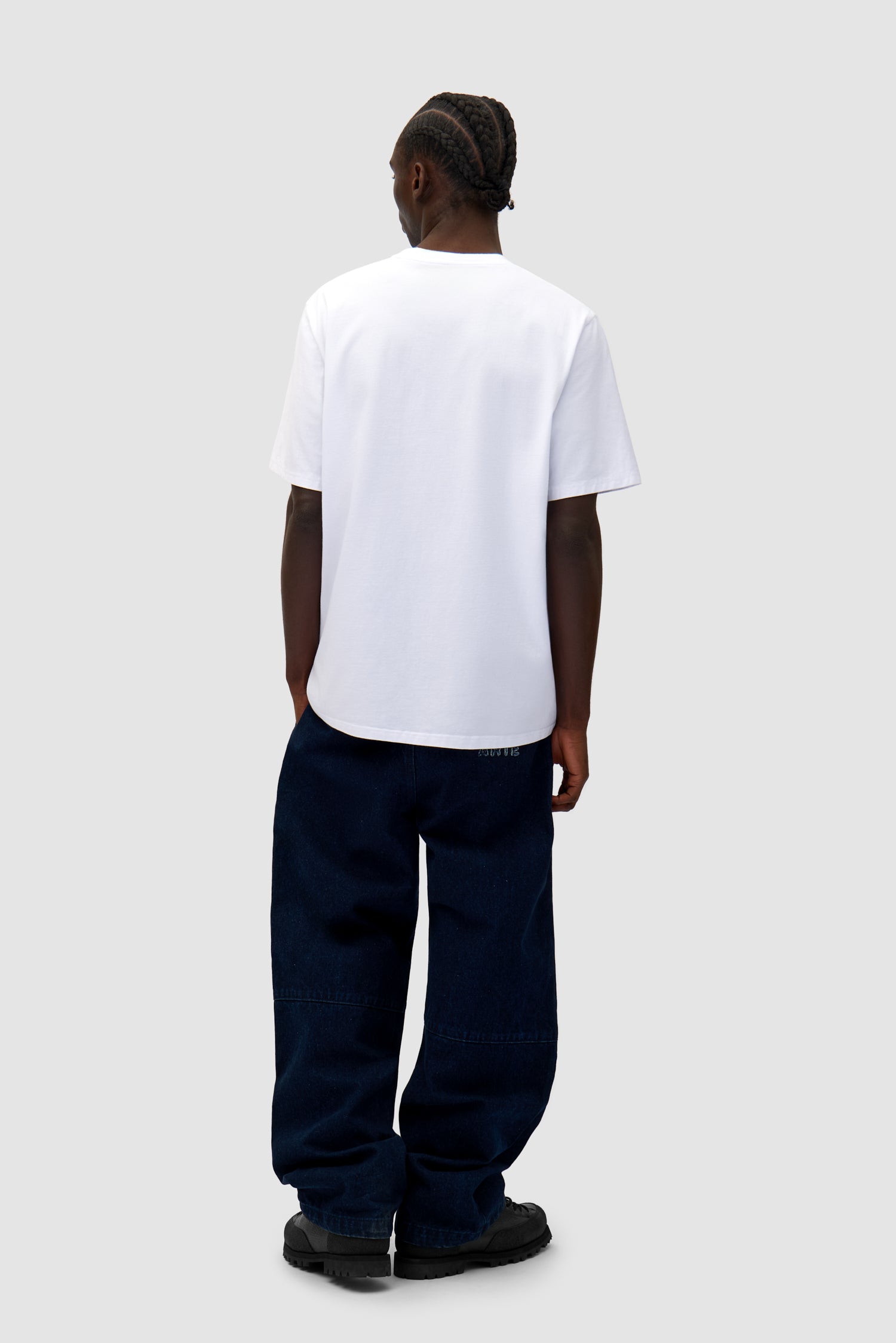 Big Bird Logo T-shirt in White worn by a model, full-body back view