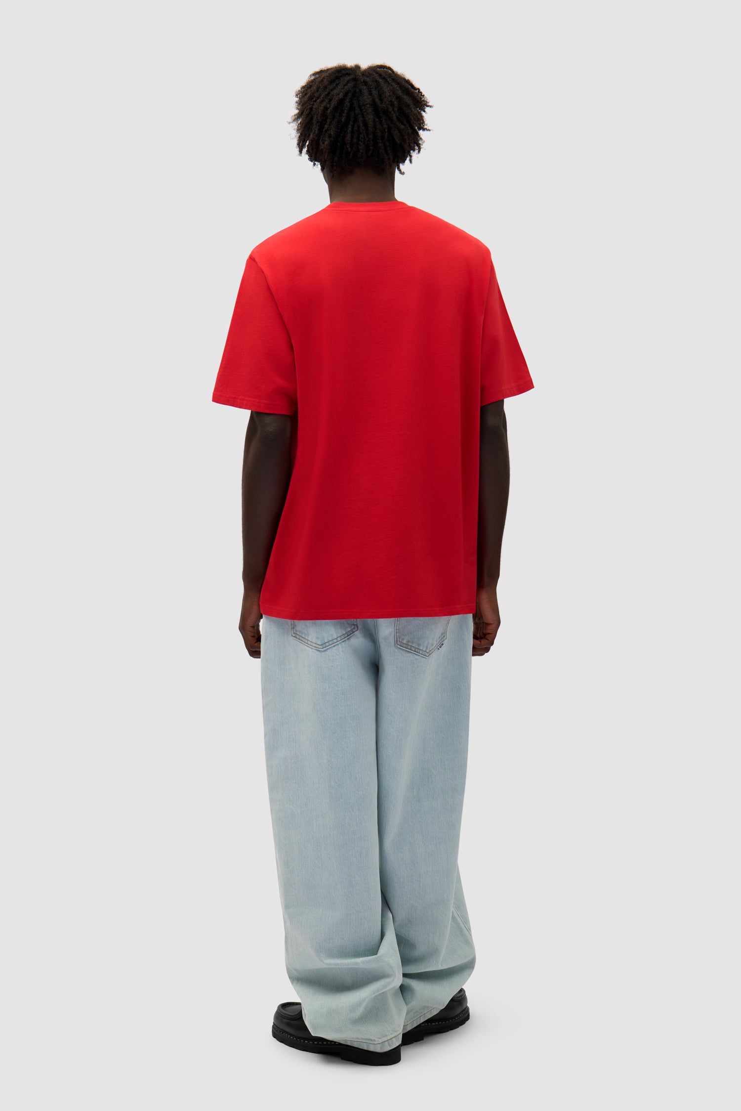 Small Bird T-shirt in Red worn by a model, full-body side view