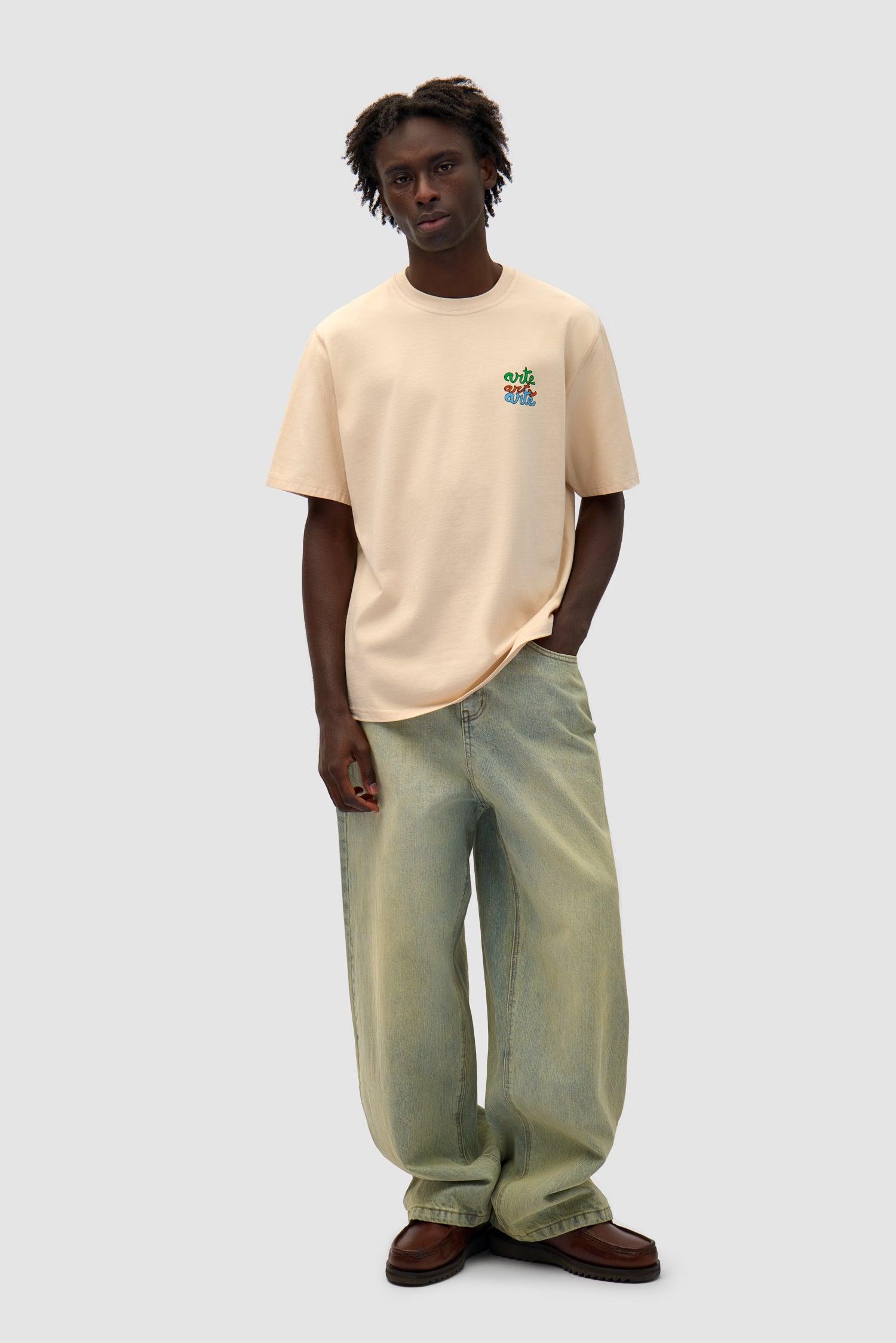 Multi Logo T-shirt in Cream worn by a model, full-body front view