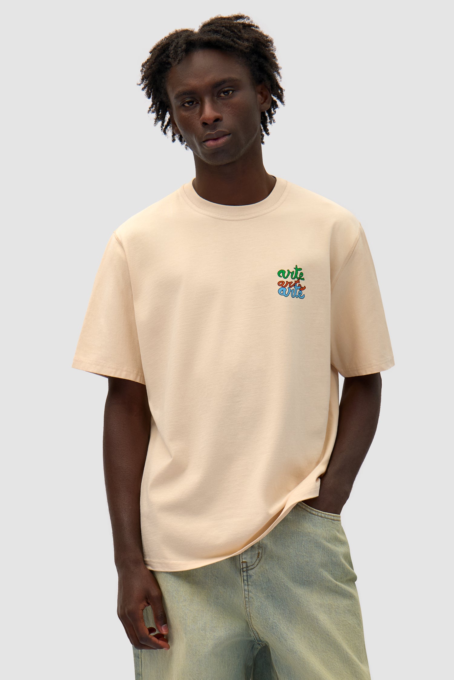 Multi Logo T-shirt in Cream worn by a model, half-body front view